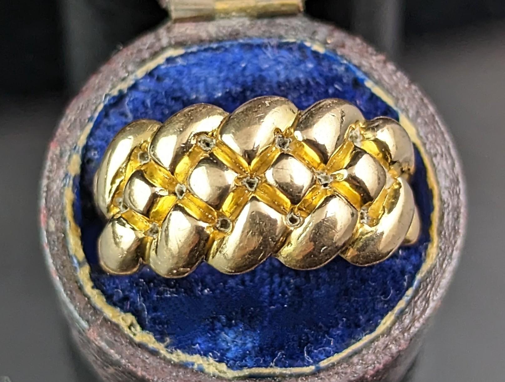 This antique 18ct gold Keeper ring is an absolute dream!

This is one of the best keeper rings I have come across with it's interesting and unique pillowy knot design and superbly rich 18ct yellow gold.

It is super chunky with a good weight and