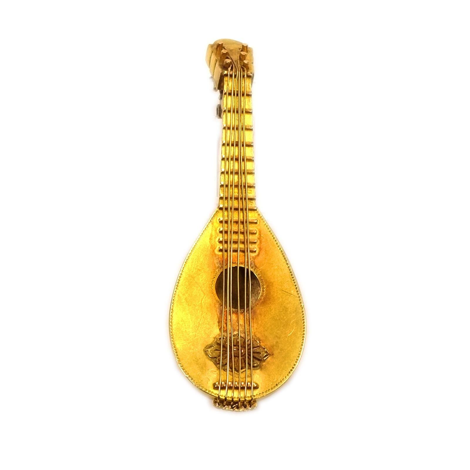 Antique 18K Gold Mandolin Brooch, Paris circa 1880

Delicate gold brooch in the shape of a mandolin, very filigree and detailed, even the six strings have been recreated. Made with exquisite craftsmanship, the attention to detail is outstanding.

