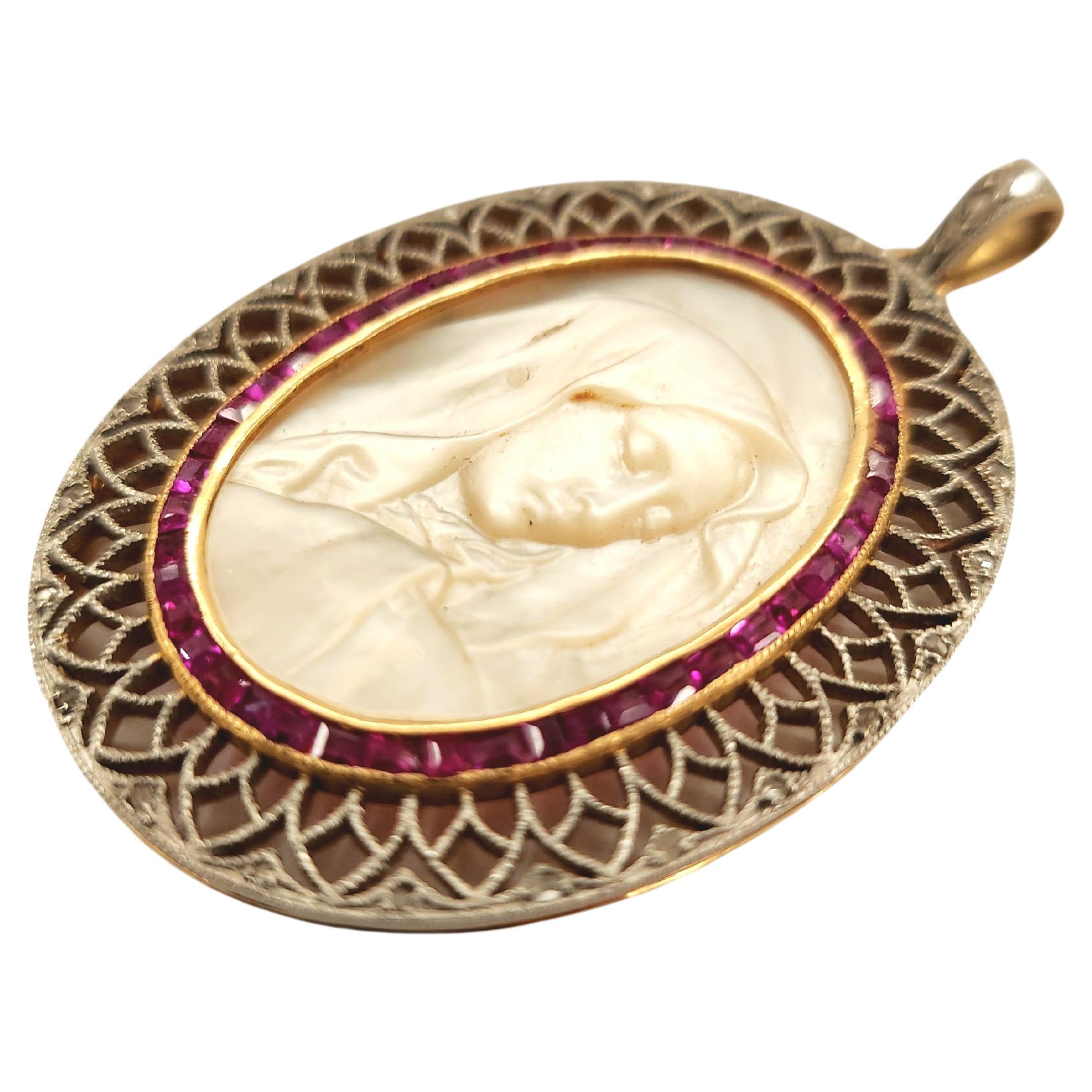 Antique 18k gold pendant with virgin marry portrait in mother of pearls flakned with natural baguet cut rubies and old diamonds with total pendant lenght 5cm hall marked 18k gold dates back to europe 1910/1920.c