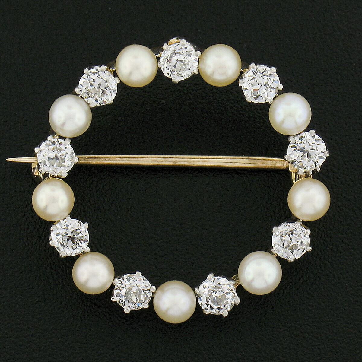 This absolutely gorgeous antique brooch was crafted during the Edwardian era from solid 18k yellow gold and platinum. It features an incredible circle of pearls and diamonds that alternate throughout its simple circular wreath design. The beautiful