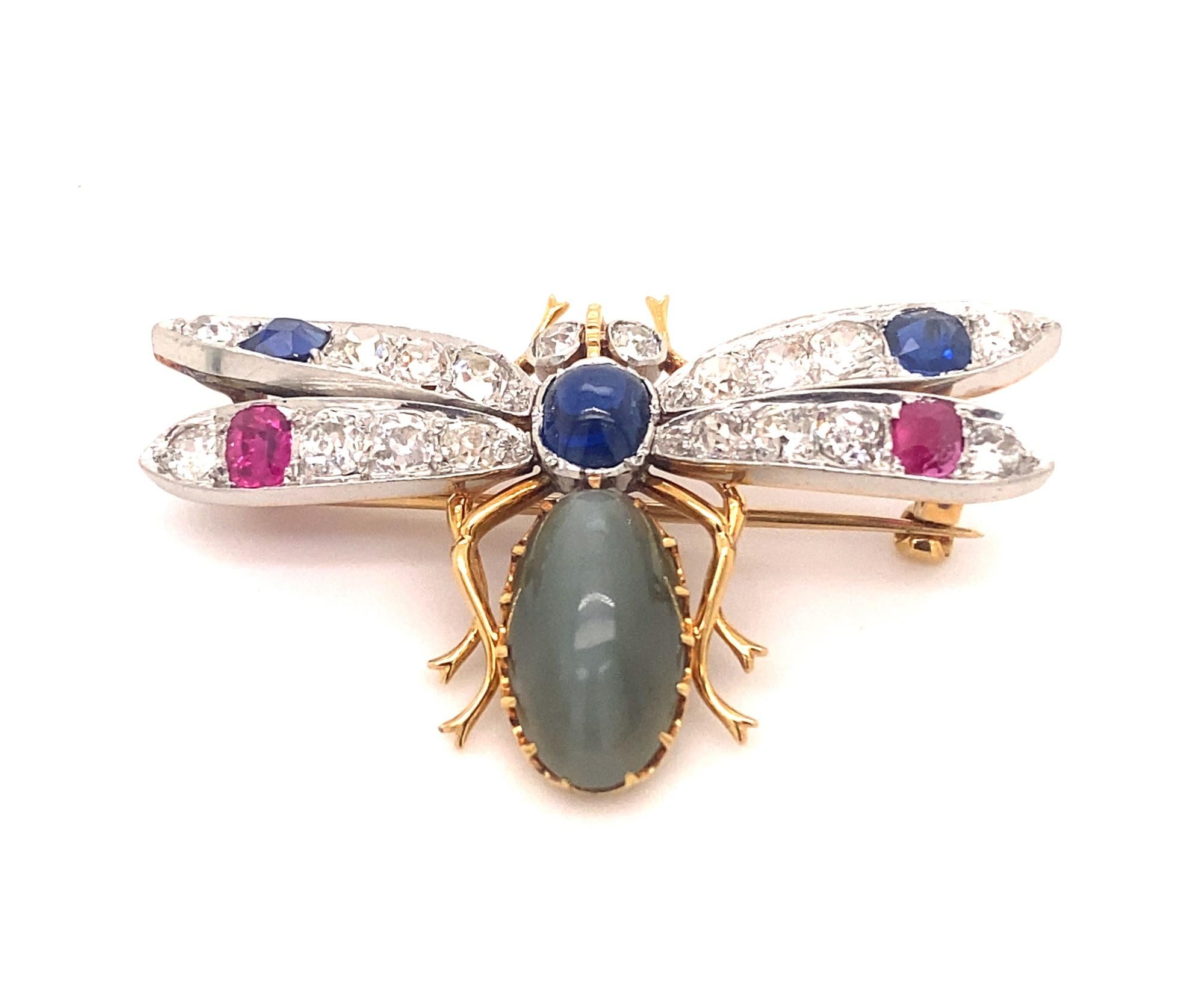 Antique Unique Circa 1890 18K Gold Platinum Superb Gem Cats Eye, Diamonds, Rubies and Sapphires Insect Brooch. The brooch weighs 11.3 grams. There is a superb natural cabochon cats eye chrysoberyl measuring approximately 4 carats set in the body of