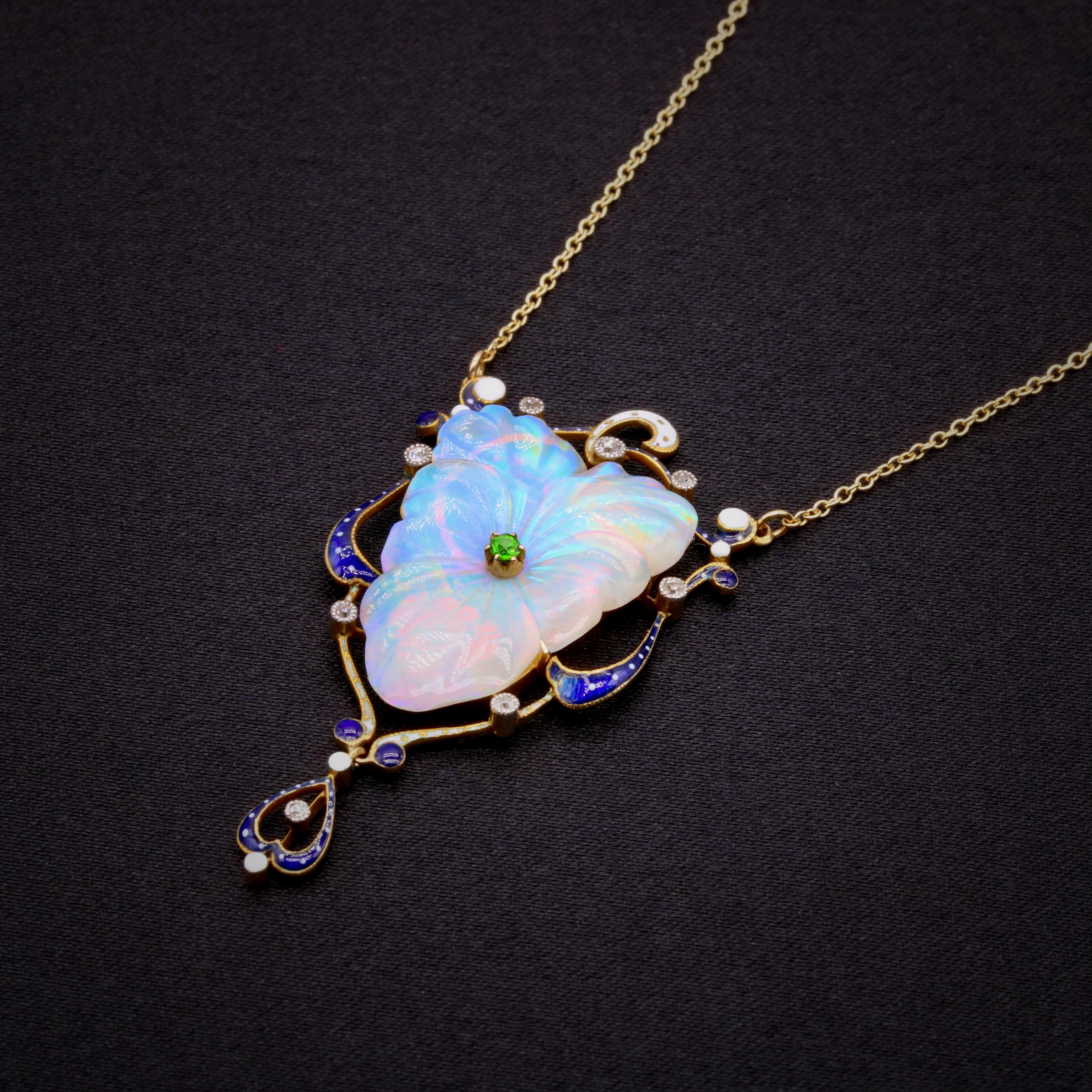 An antique opal, demantoid garnet, diamond, enamel, platinum and yellow gold necklace, comprising one carved opal, one round cut demantoid garnet, eight old single cut diamonds, and white and blue enamel, set in 18 karat yellow gold and platinum, to