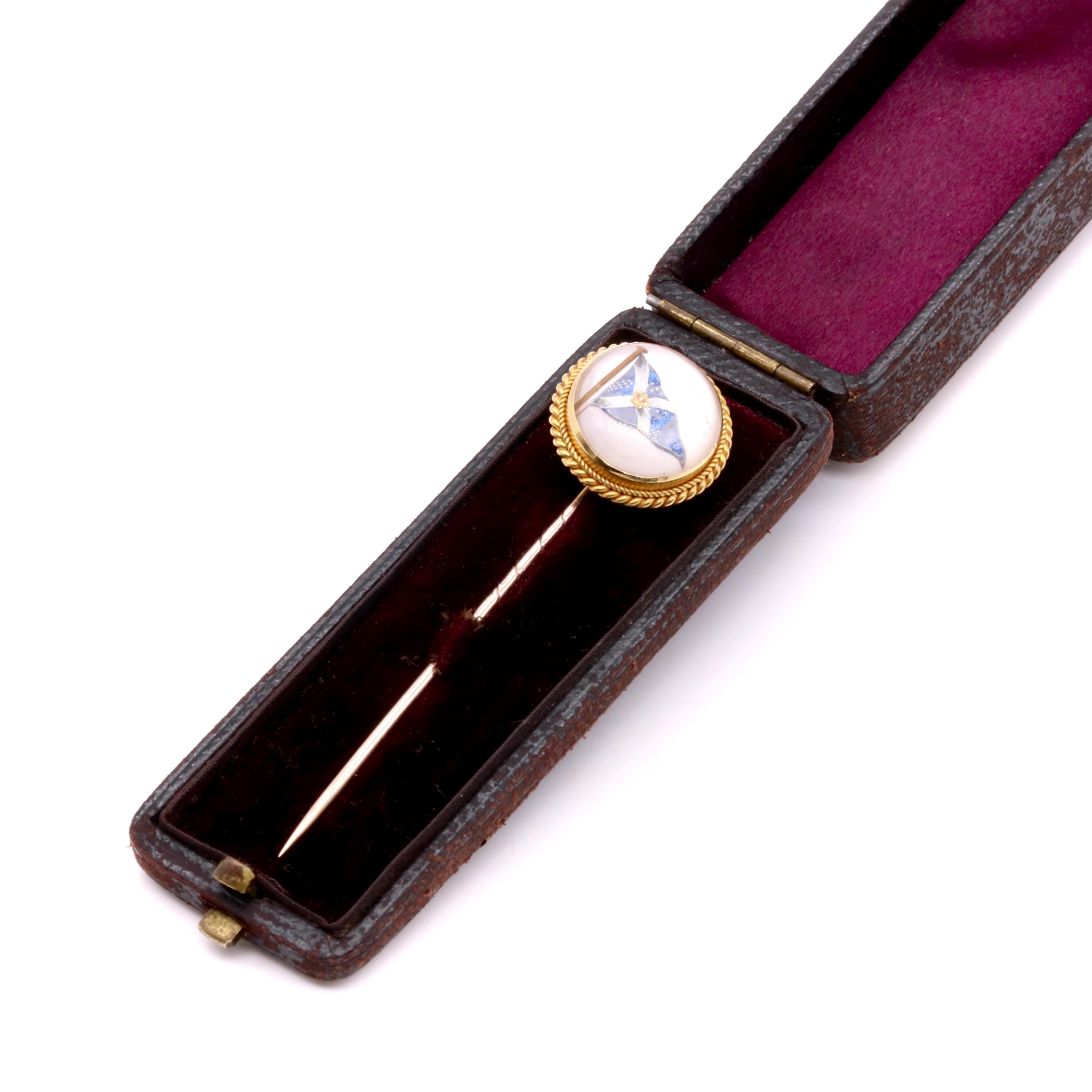 An antique rock crystal, and yellow gold stick pin, comprising one round rock crystal cabochon, backed with mother of pearl, set in 18 karat yellow gold, with 10 karat yellow gold pin. 

This stick pin features a circular, domed cabochon of rock