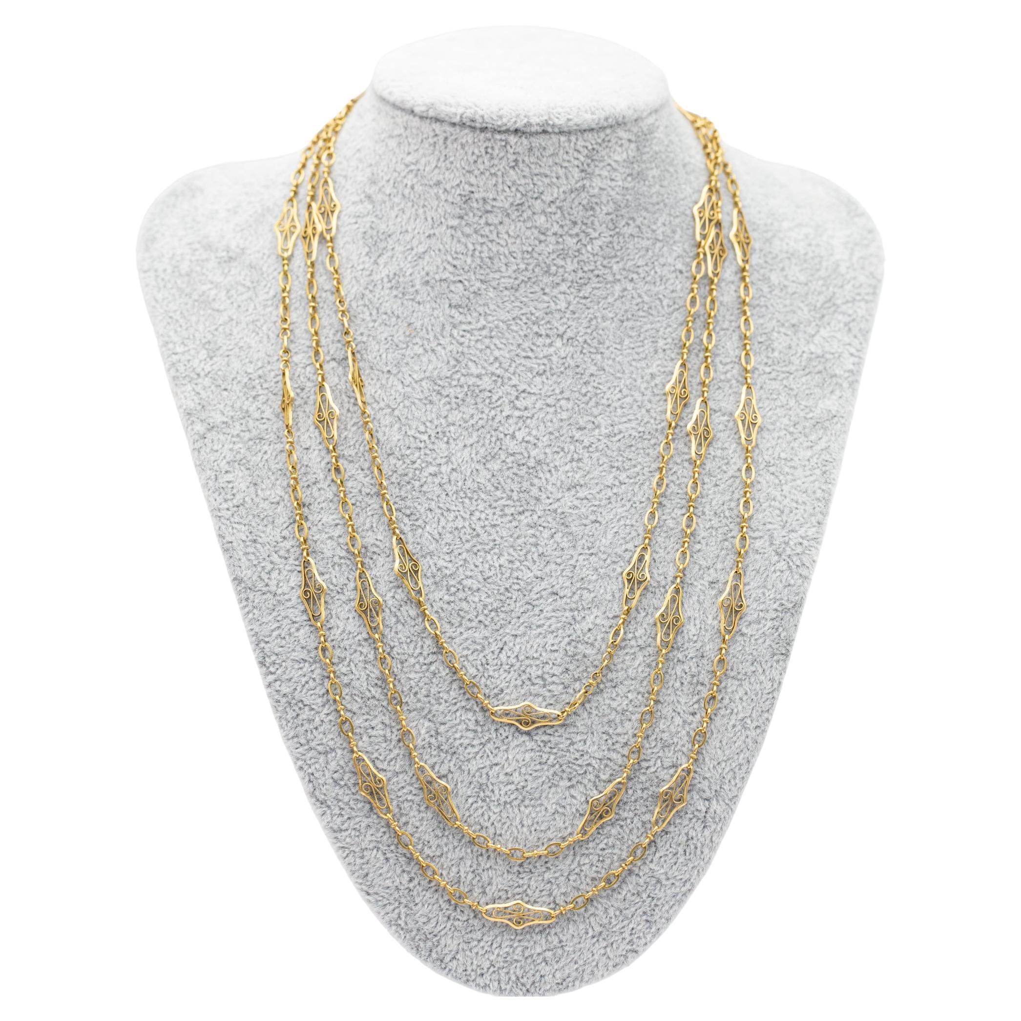 For sale is this lovely 18 K yellow gold sautoir necklace that can be worn as a single, double or triple stand. This elegant necklace consists out alternating simpler and fancy looking links with lovely filigree scroll decorations and millegrain