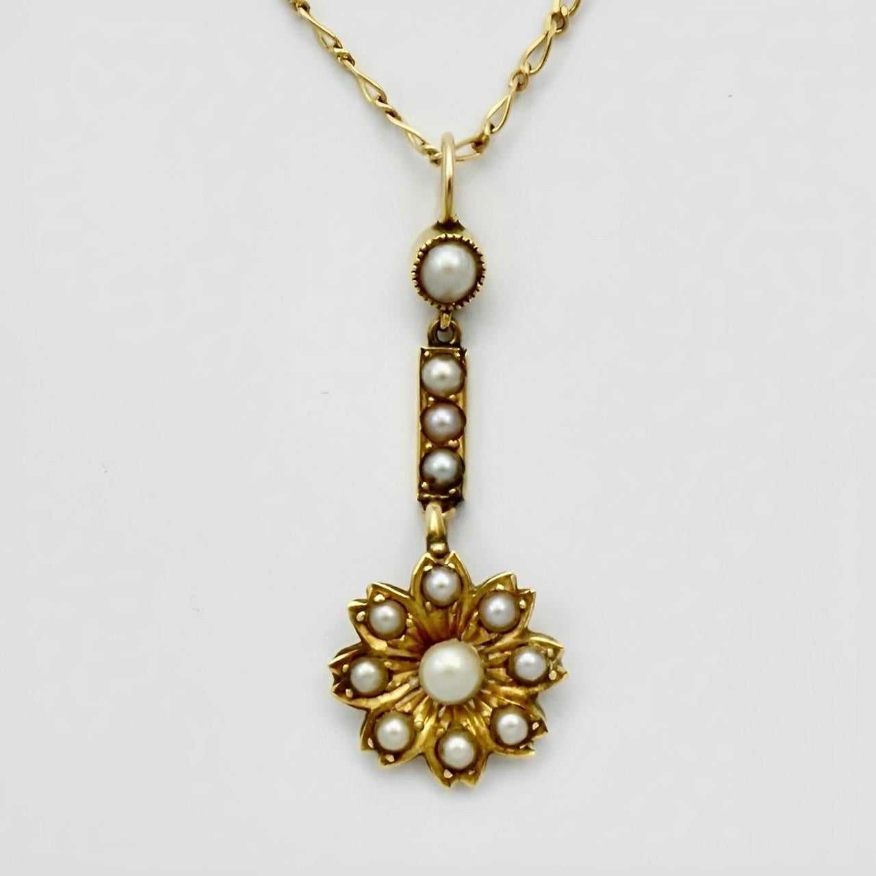 Lovely antique gold and seed pearl flower drop pendant with a 9K gold figaro chain necklace. The antique pendant is not marked but tests as 18K gold. The Italian gold necklace is of a later date than the pendant. Measuring length 50 cm / 19.6