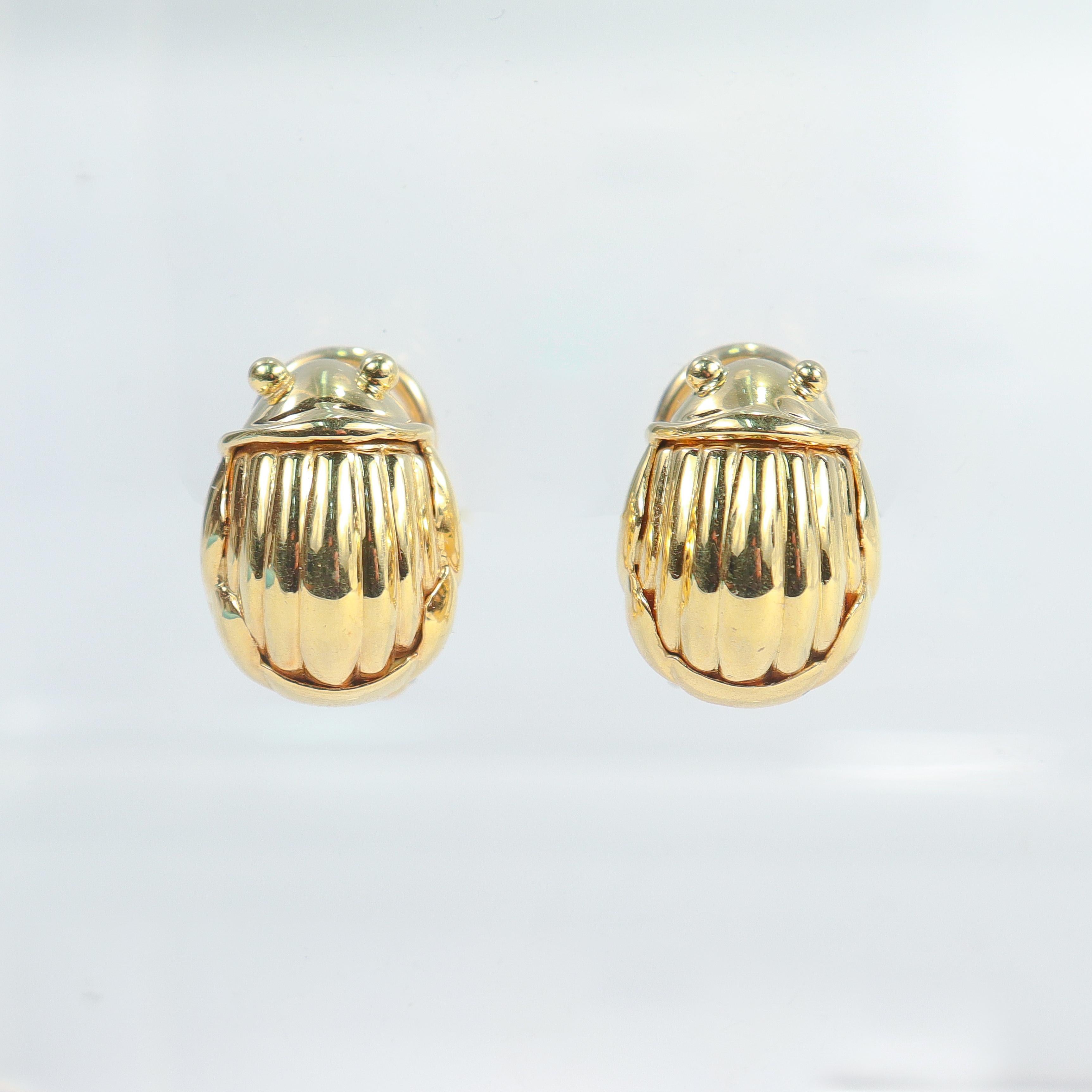 A fine pair of gold scarab beetle earrings.

By Tiffany & Co.

In 18K yellow gold.

In the form of scarab beetles with round (granulated) eyes and striped backs. Set with omega clip ear backs for extra security.

Simply wonderful, whimsical Tiffany