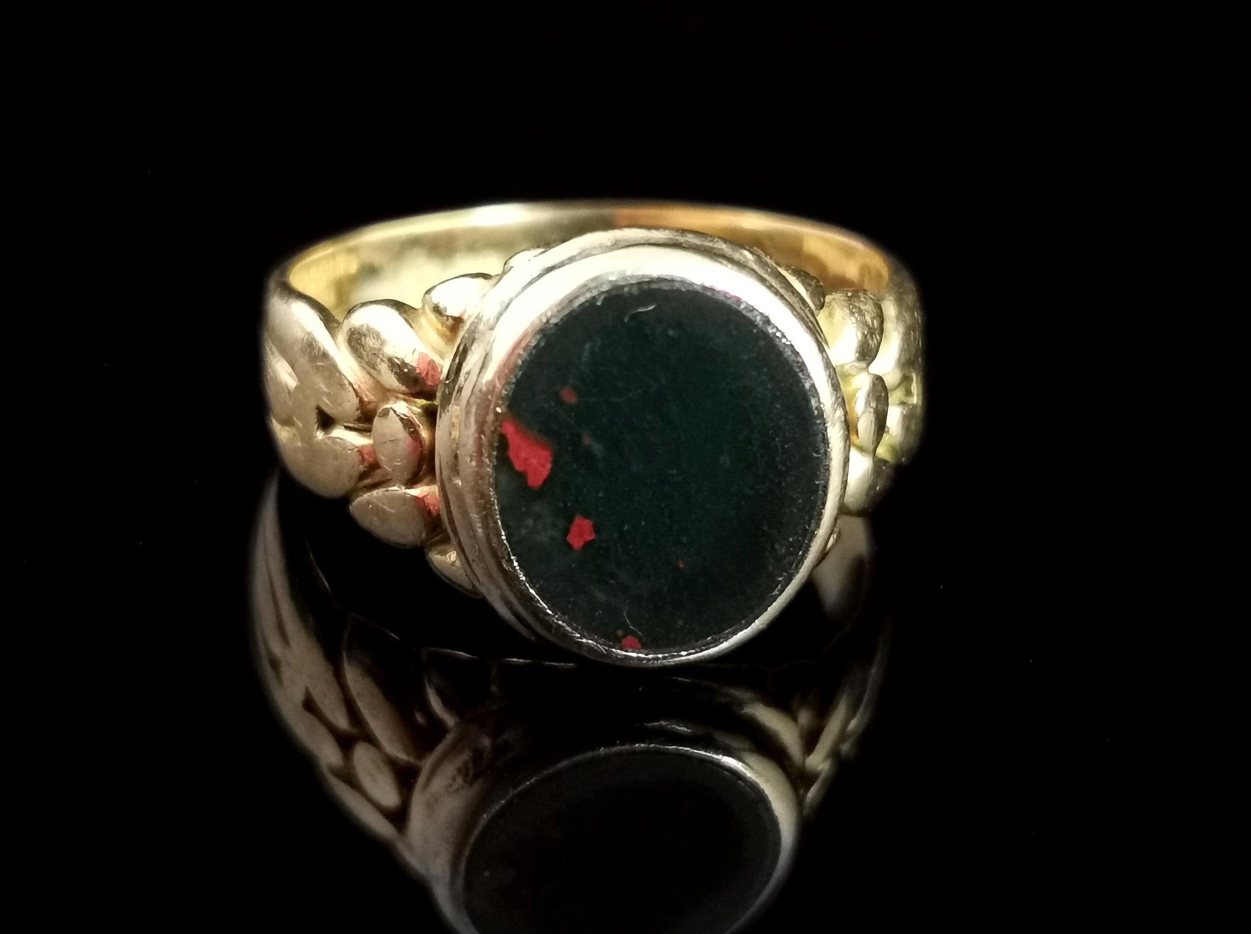 A gorgeous antique, Edwardian era 18 karat gold and bloodstone signet or seal ring.

This gorgeous ring has an unusual design in that the shoulders are styled in a similar way to a keeper ring, nice and chunky the bear way to a round bezel set