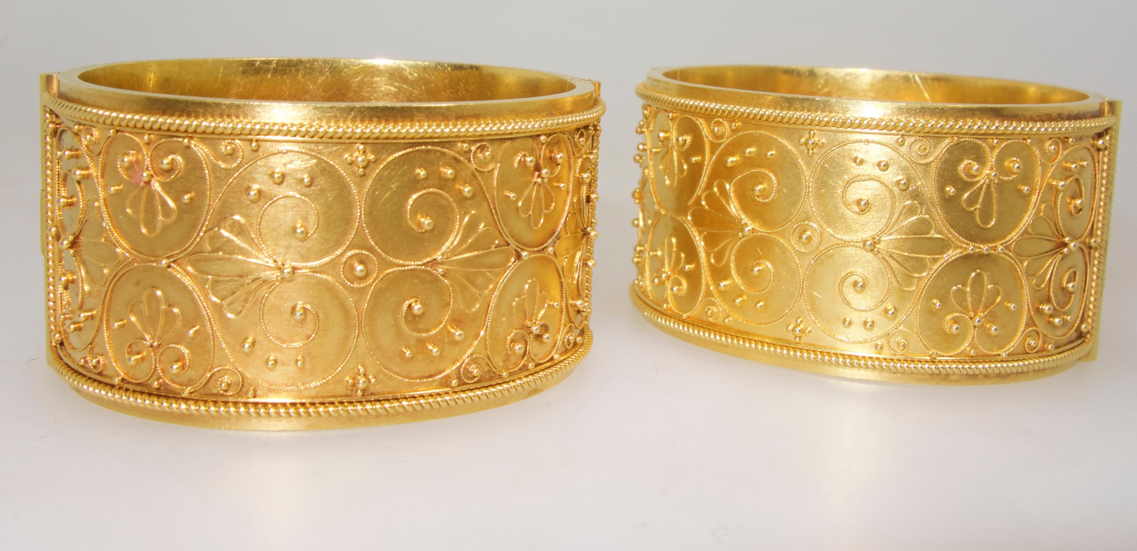 Antique bracelets with excellent example of Etruscan revival gold work.  Probably made for a young girl as the inner circumference is 5 7/8 inches.  The width of each bangle is 1 1/8 inches.  Condition we would rate as very good.  A very slight