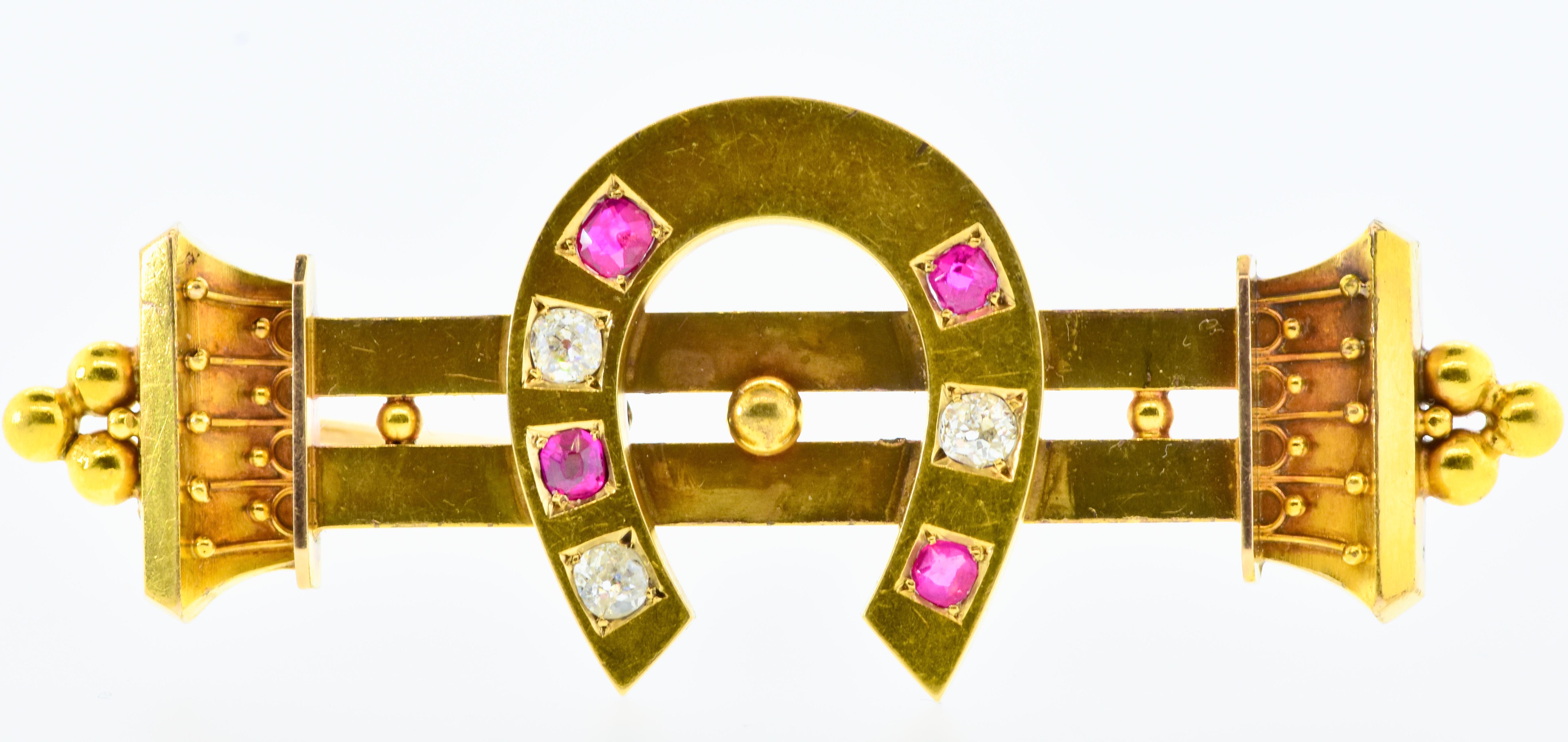 Antique 18K brooch with 3 old cut diamonds and 4 old cut rubies.  Perfect also as a stock pin, this equestrian motif of a horse shoe is made well and in fine condition for such an early piece.  The horse shoe (symbolizing good luck), had .35 cts of