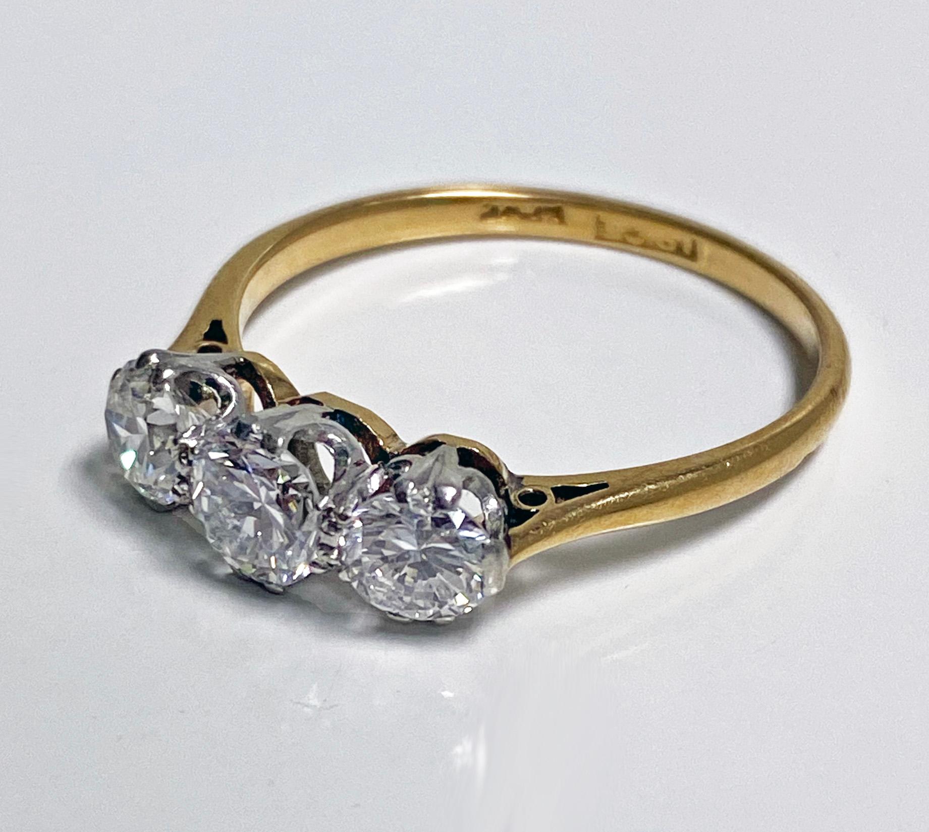 Antique 18K Platinum Diamond Ring, C.1920. The three stone diamond Ring set with three early round brilliant cut diamonds approximately 1.14 cts total diamond weight, average VS clarity, average H-I colour, plain basket setting and shank. Centre