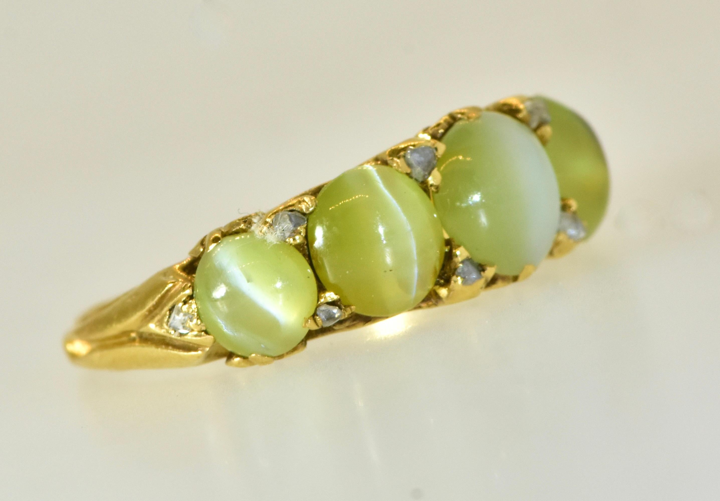 Antique ring with fine and 5 fine Cat's Eye Chrysoberyl natural stones set across the finger and interspersed with 10 small tiny rose cut diamonds as accent stones.  The estimated weight by our internal gemologist is 2.7 cts.  These very unusual