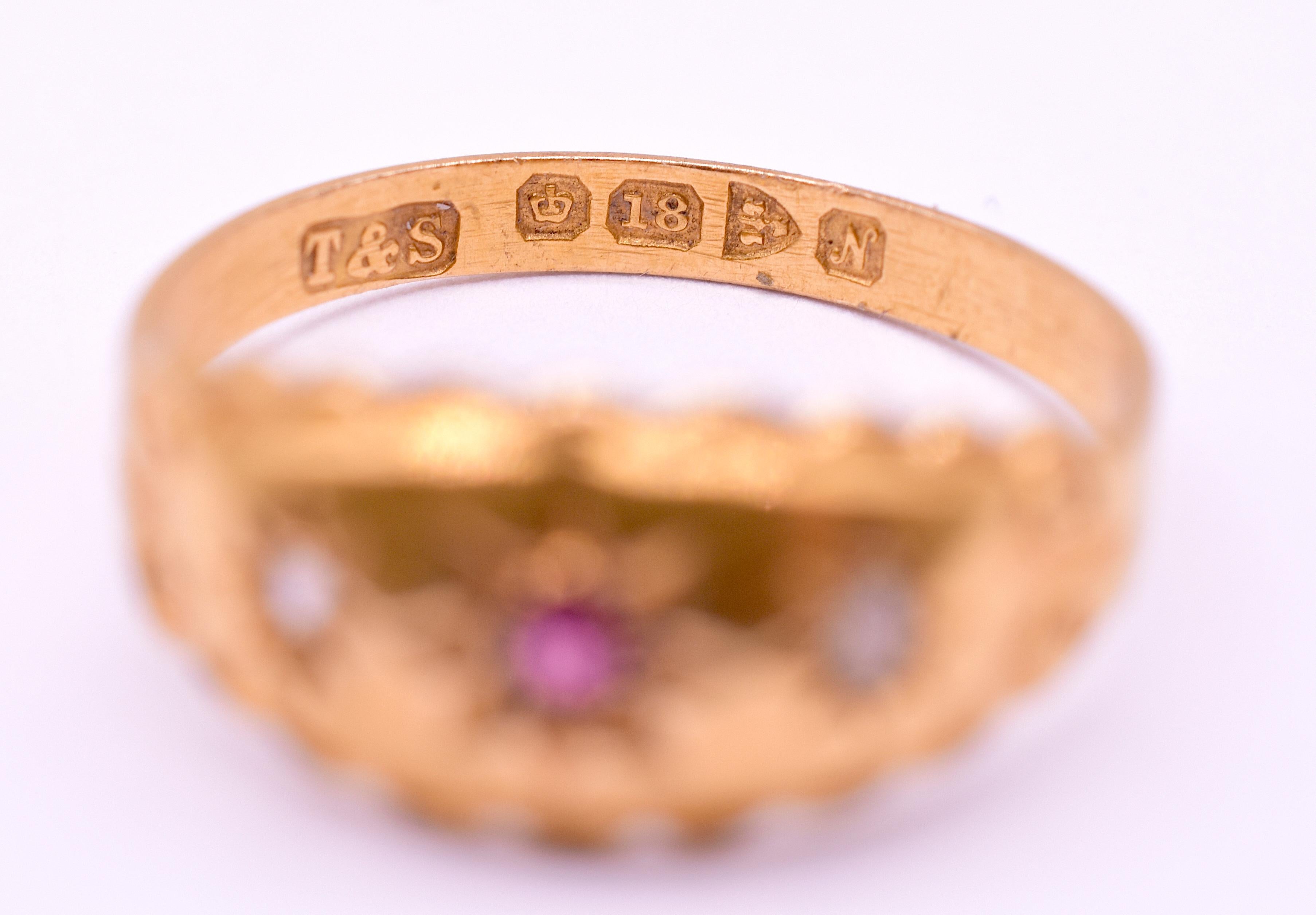 Our 18K flush mount ring features 2 cushion cut diamonds and 1 central ruby encased in 8 pointed stars on a polished gold band with a charming incised design on each shoulder and an unusual scalloped edge. Flush mount gypsy rings are one of the most