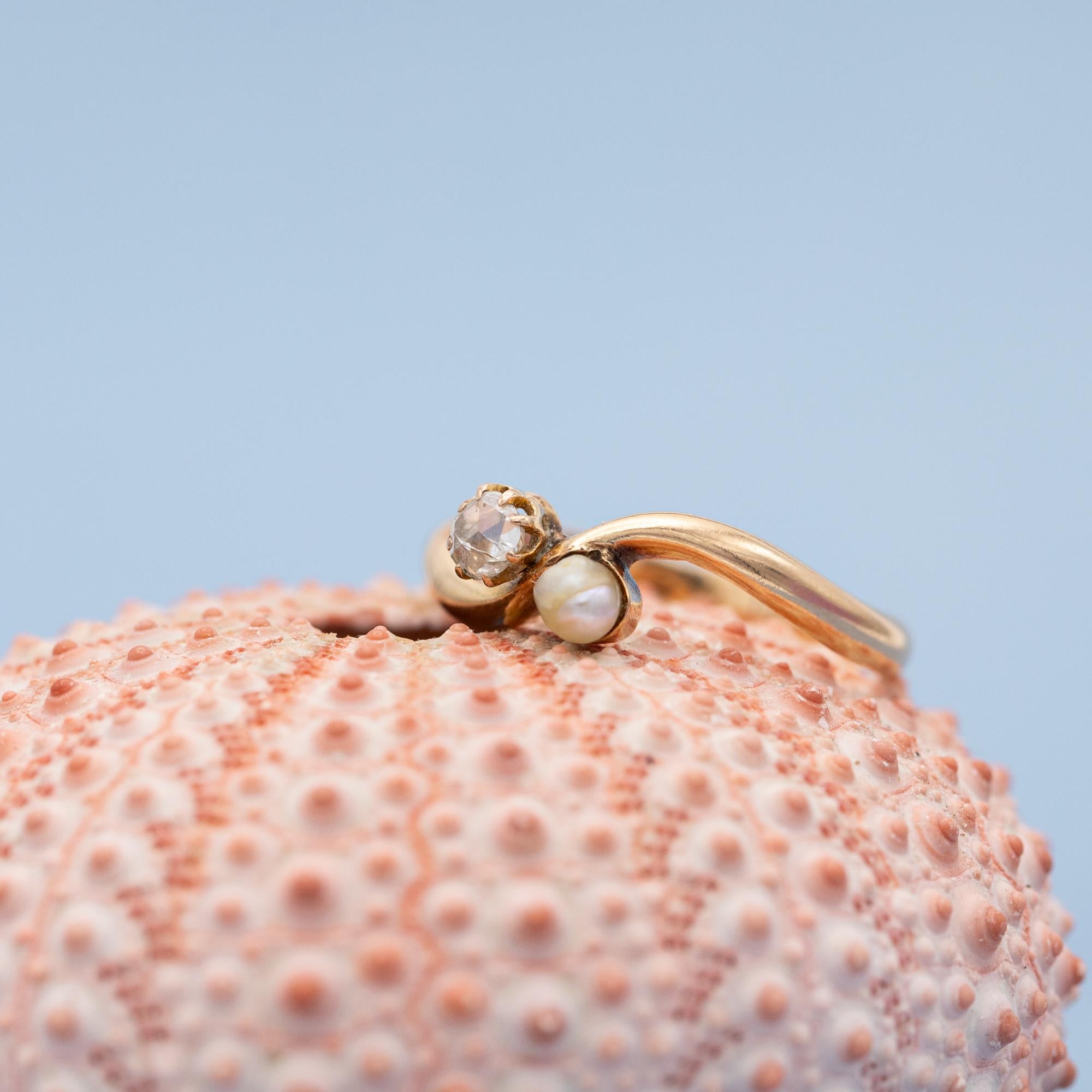 For sale is this Lovely two stone crossover ring. These rings are also known as 'Toi et Moi', which is French for 'you and me'. It is an incredibly romantic meaning of the joining of two souls in love. This ring is crafted in 18 karat rose gold, and