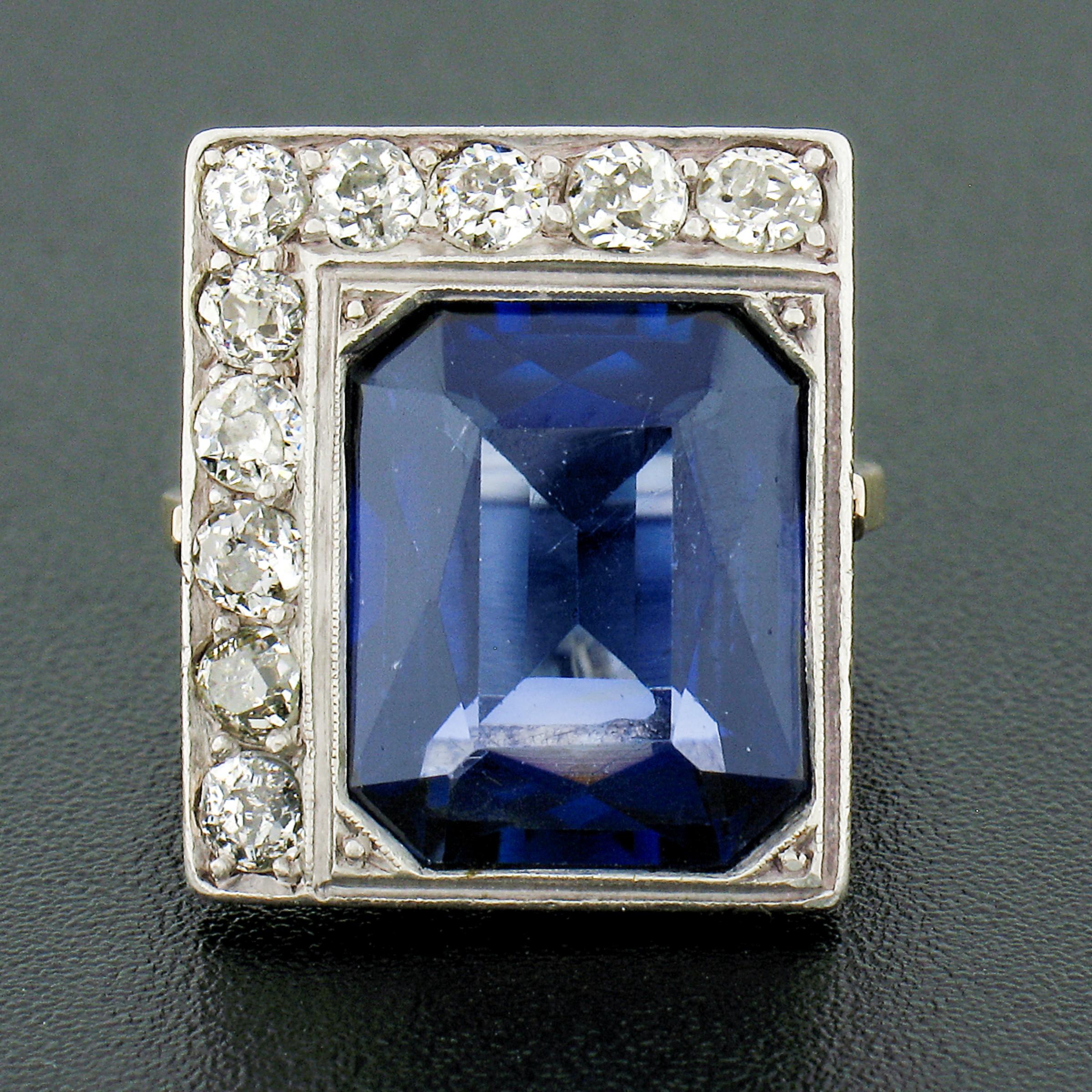 This gorgeous and unique looking antique platter ring was crafted during the 1910's from solid 18k yellow and white gold and features a large blue stone that is neatly half-framed with fine diamonds. The blue stone is milgrain bezel set at the side