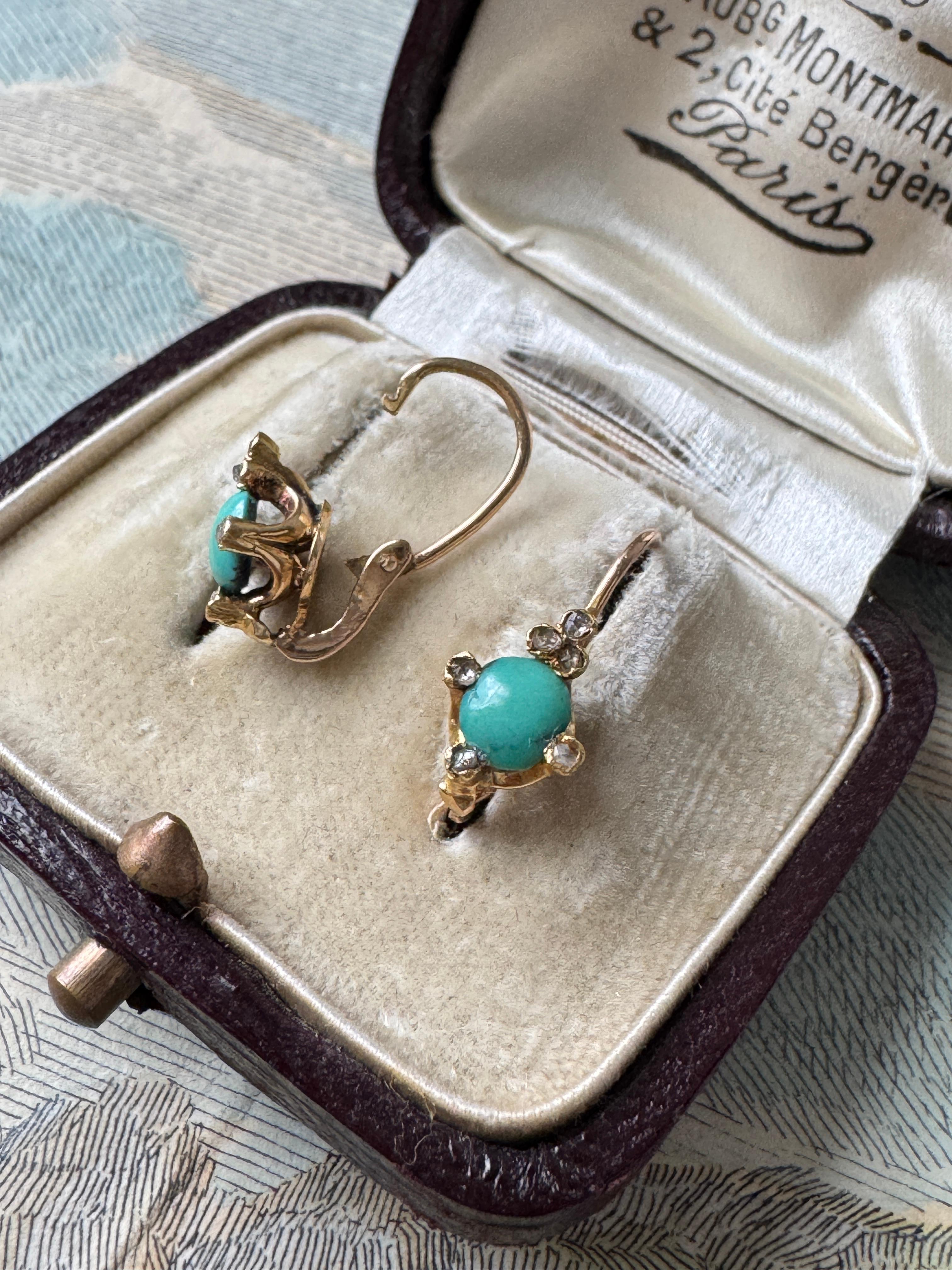 Hailing from the late 19th century, these delightful dormeuses showcase cheerful turquoise cabochons, cradled by twinkling rose-cut diamond tipped prongs at each compass point. Complete with their original back-to-front closures, these little