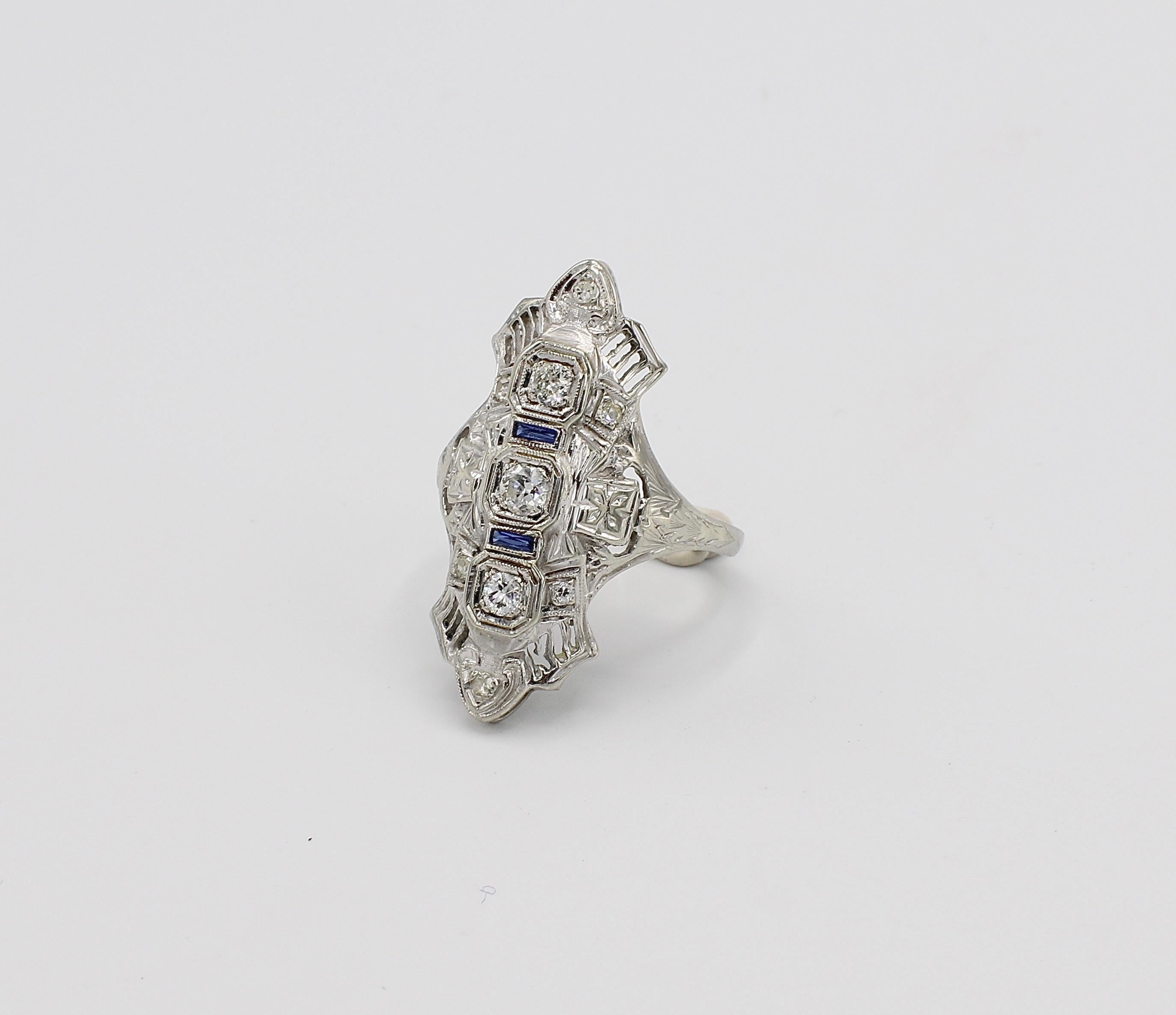 Antique 18K White Gold Natural Diamond & Sapphire Navette Cocktail Ring Size 5.5
Metal: 18k white gold
Weight: 4.5 grams
Diamonds: Approx. .30 CTW round natural diamonds G VS 
Size: 5.5 (US)
Top of ring measures 28mm x 15mm

