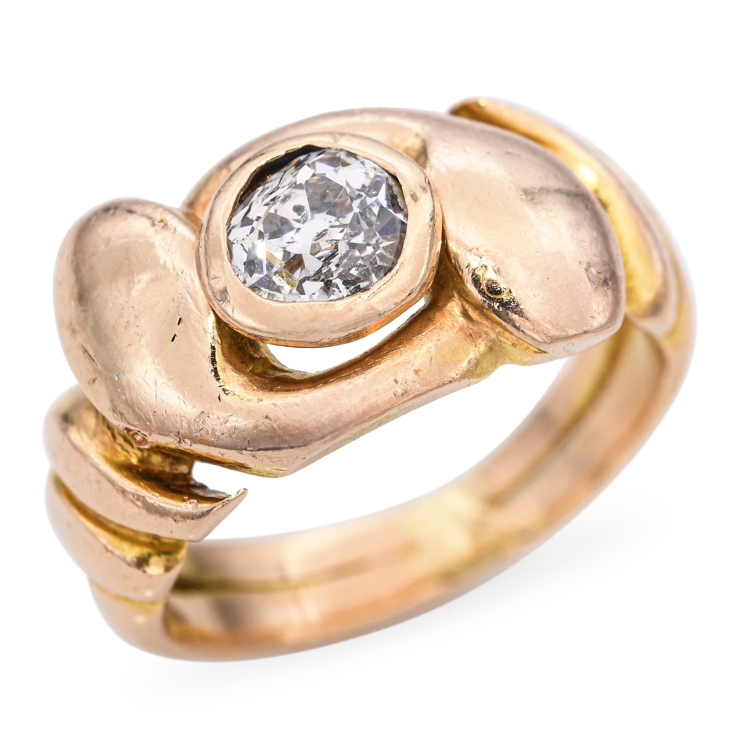 This captivating antique ring is crafted in 18k yellow gold and features an intertwined snake motif symbolizing eternity and protection. At the center, a 0.50ct Old European cut diamond adds a touch of antique brilliance to the design. The detailed