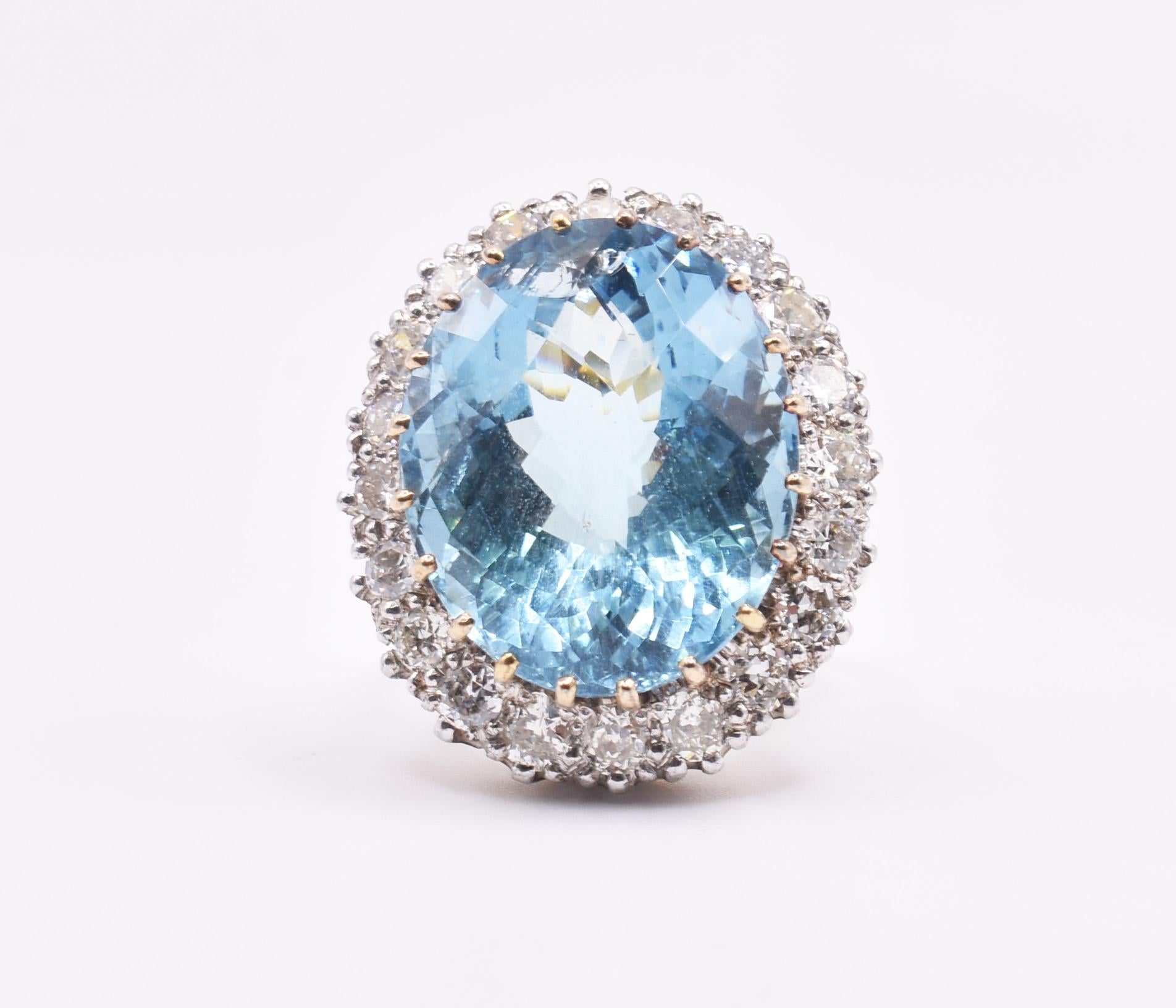 A fine quality antique 18k yellow and white gold aquamarine cocktail ring, boasting a stunning pineapple cut 16ct aquamarine to the centre, of superb colour, in a pronged setting, surrounded by 20 old cut diamonds, totalling approximately 2.40ct.
