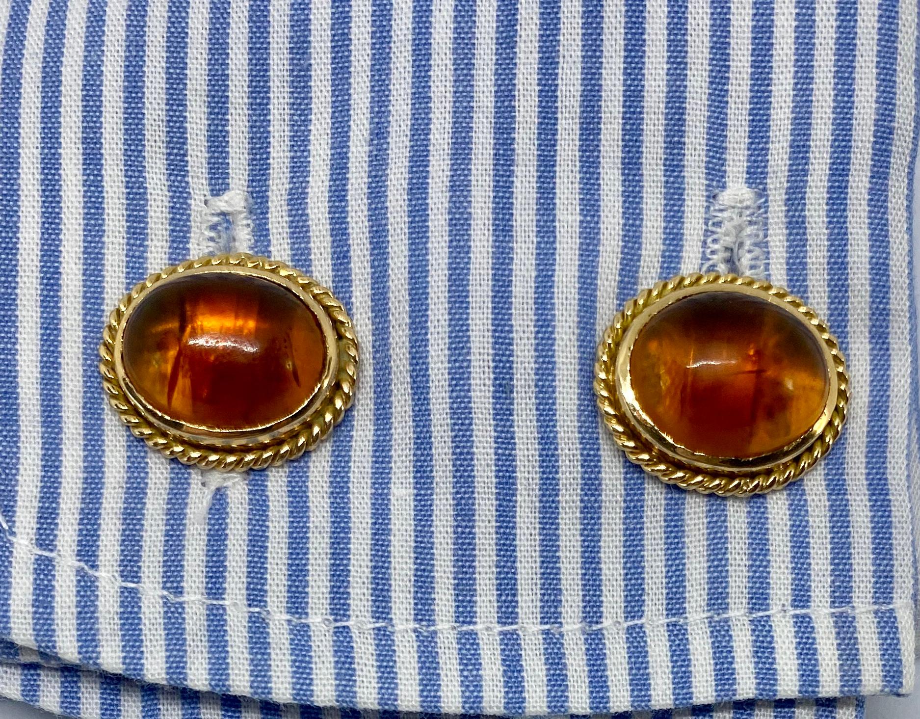 These beautiful, double-sided cufflinks feature four large amber cabochons set in solid 18K yellow gold with twisted rope detail. The amber is very high quality - bug-free and slightly cloudy from age - with a rich, 