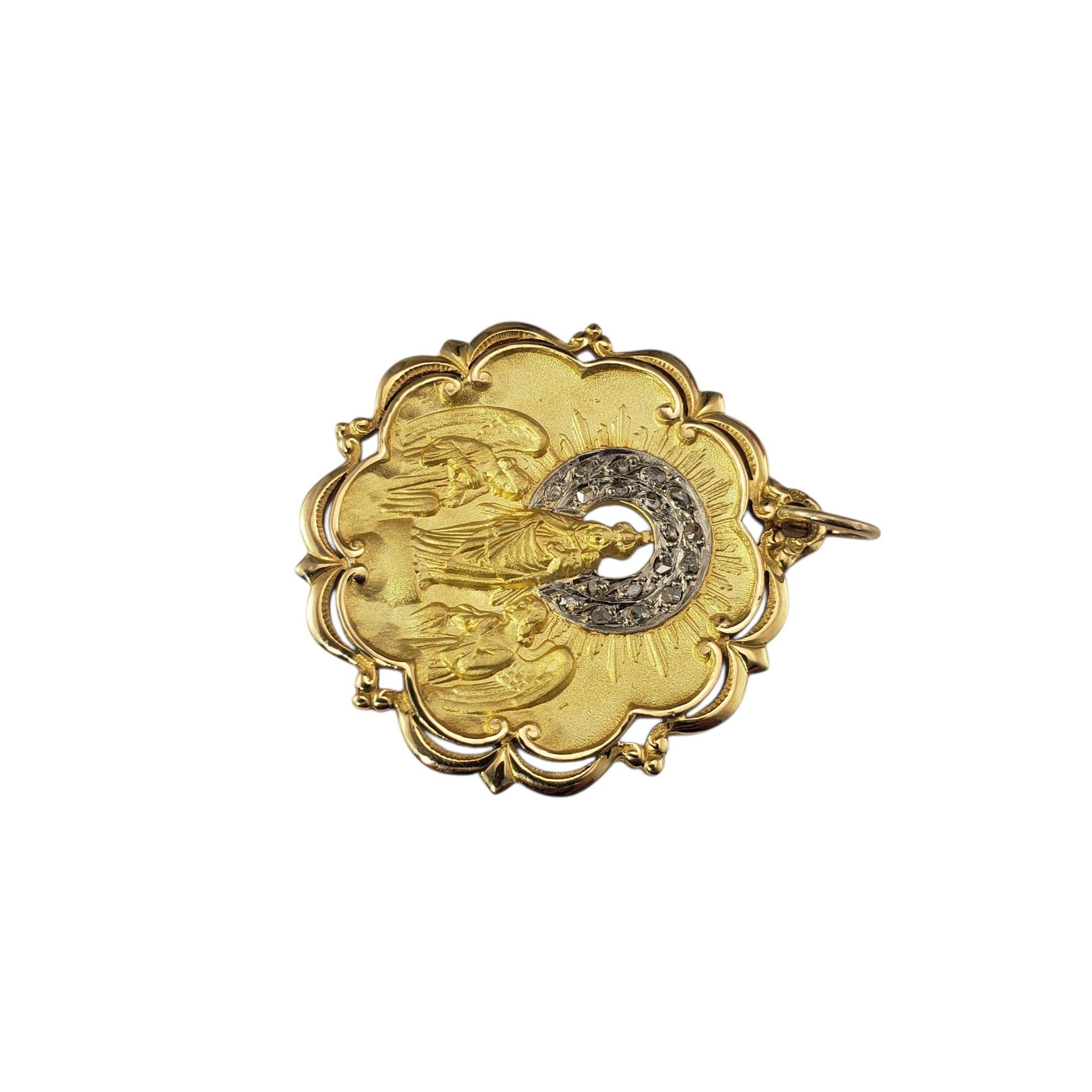 Antique 18K Yellow Gold and Diamond Virgin of Pilar Pendant-

This exquisite antique medal features a finely detailed depiction of the Virgin of Pilar, delicately rendered in 18K yellow gold with ornate raised relief work. The Virgin stands in the