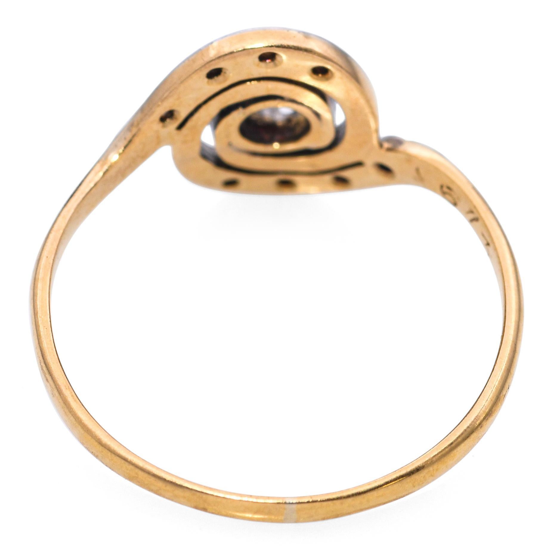 This unique antique ring features a graceful swirl design crafted in rich 18k yellow gold with a platinum overlay accentuating the diamond settings. Set with sparkling Polki diamonds—traditional uncut diamonds known for their organic brilliance—the