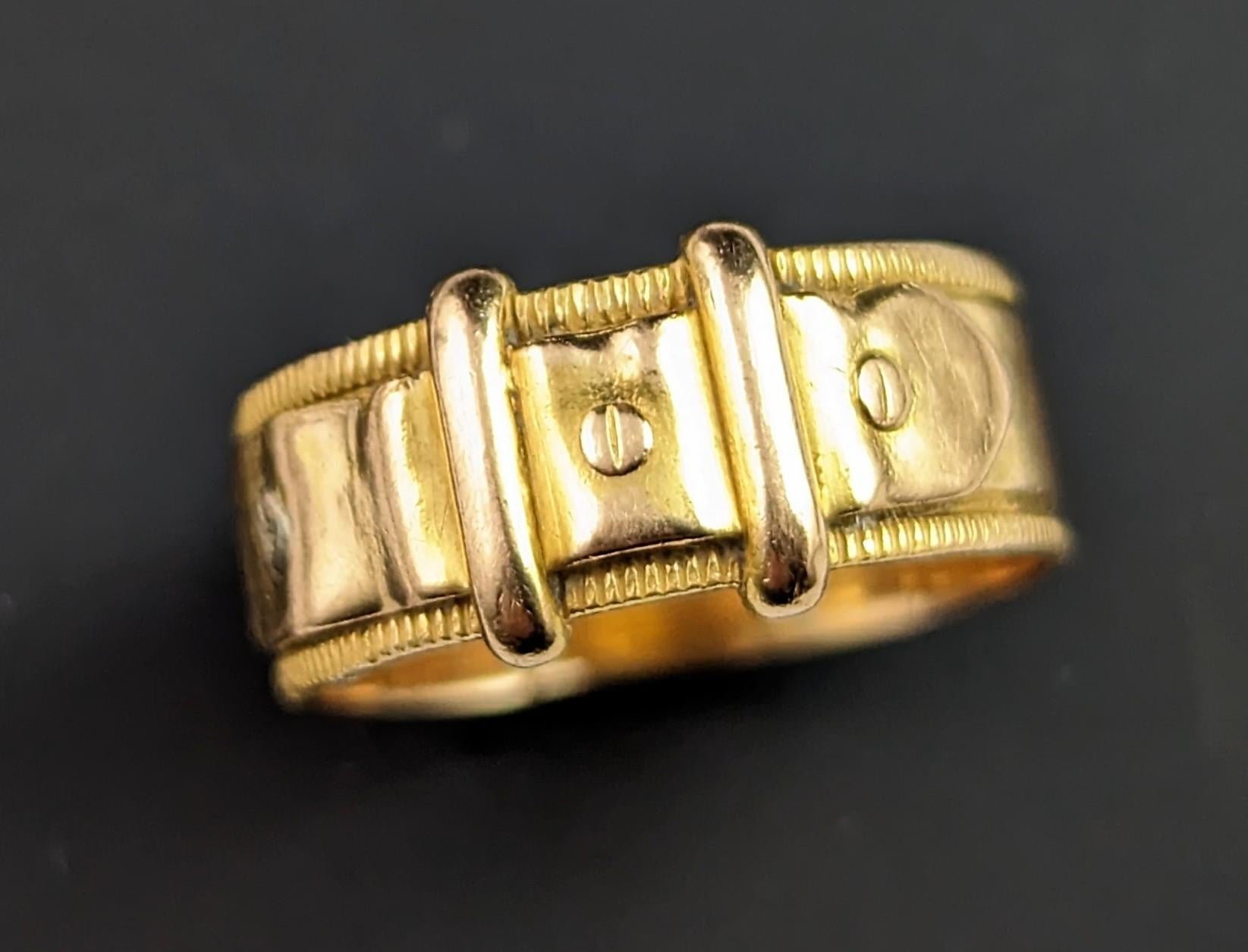 This antique 18kt gold Buckle ring is simply lush.

The rich gold band is lightly engraved and it has a buckle front design with tiny screw details, the buckle traditionally symbolises holding someone close or near and this really shows the