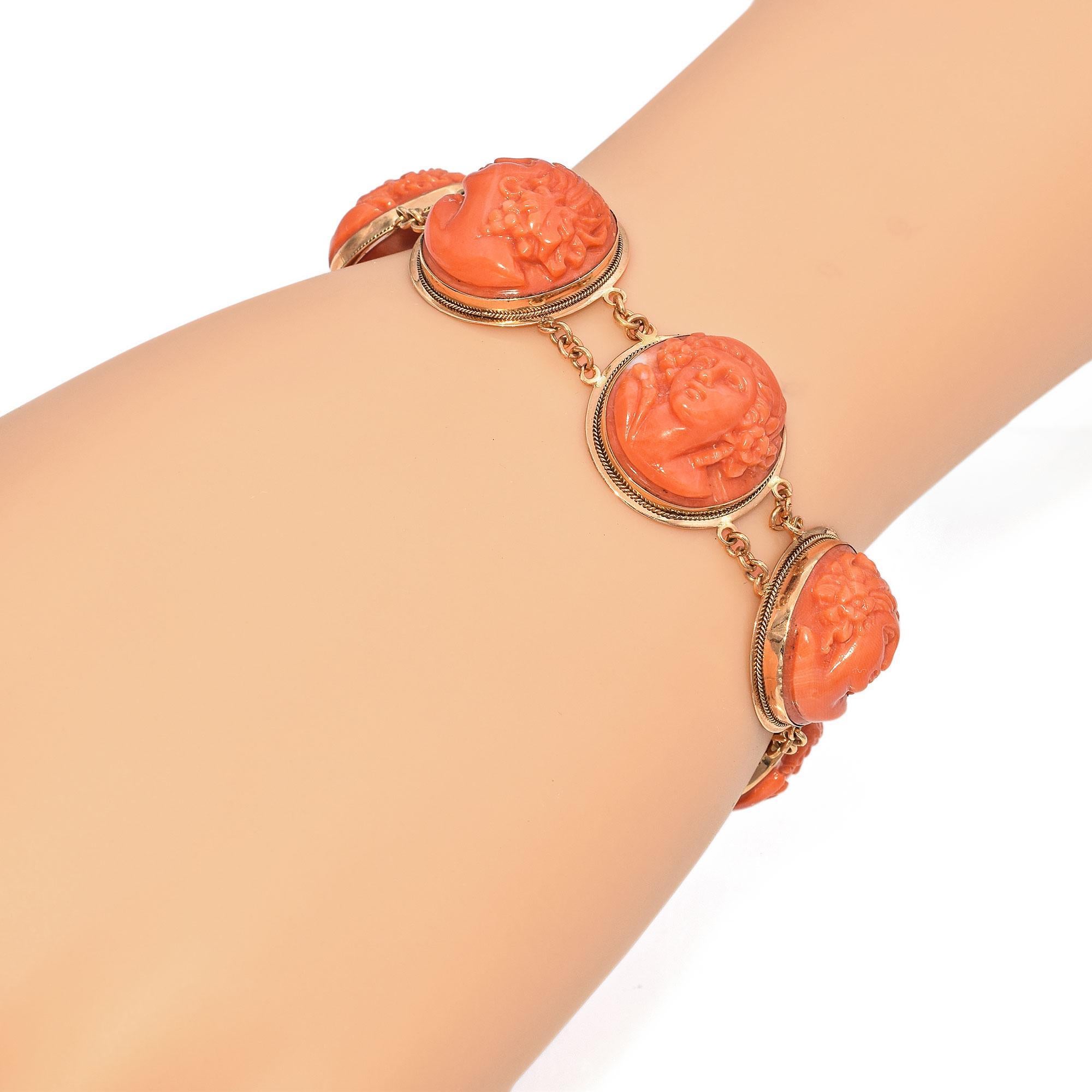 A stunning example of craftsmanship and elegance, this antique bracelet features meticulously hand-carved coral cameos set in rich 18k yellow gold. Each intricately detailed portrait showcases the artistry of a bygone era, evoking classical beauty