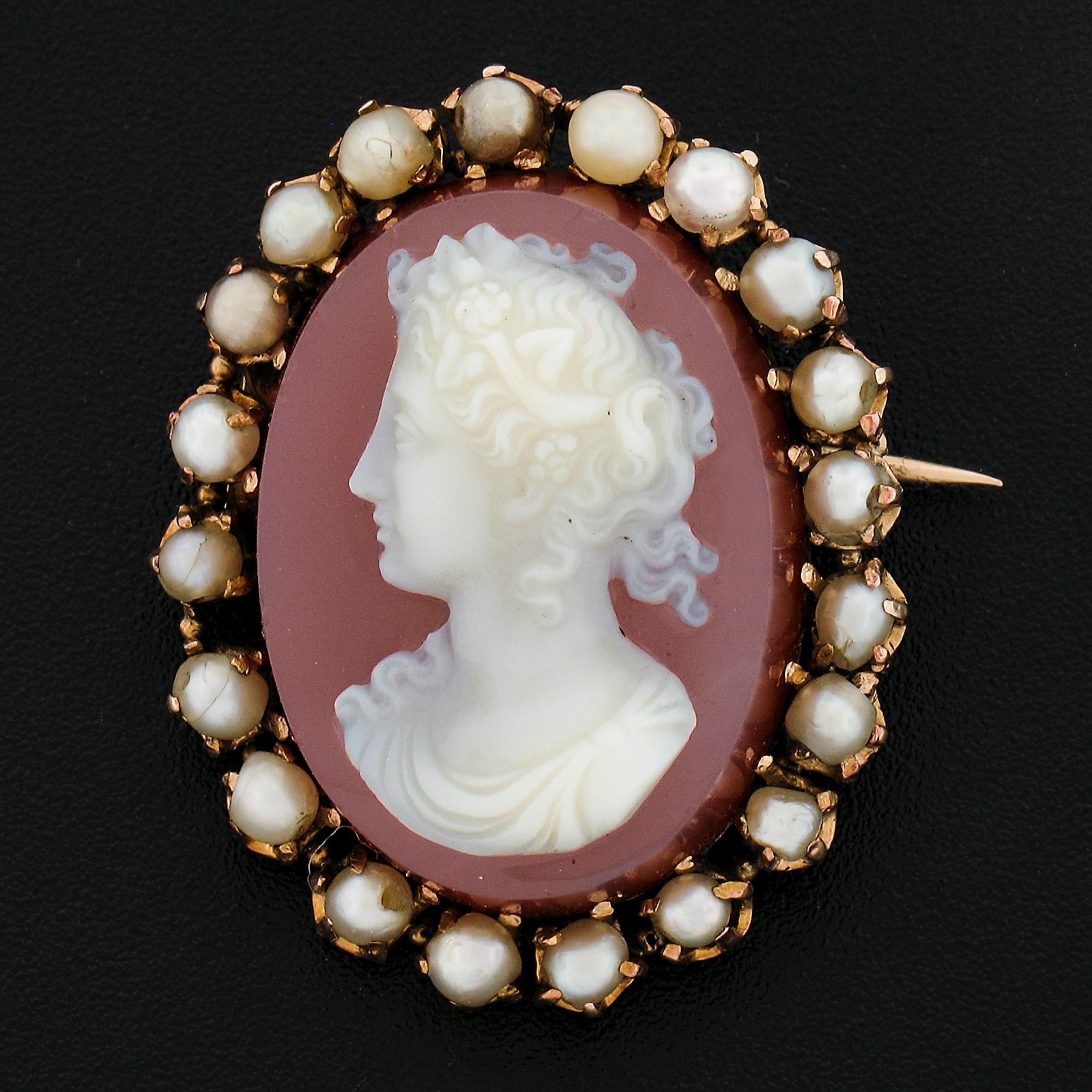 --Stone(s):--
(1) Carved Hardstone Cameo - Oval Shaped - Multi-Prong Set - Orangy-Brown Base Color w/ white Carving - 26.3x19.3mm (approx.)
(20) Genuine Cultured Pearls - Round Shape - Prong Set - Grayish White Color - Good Luster - 2.5-3.6mm