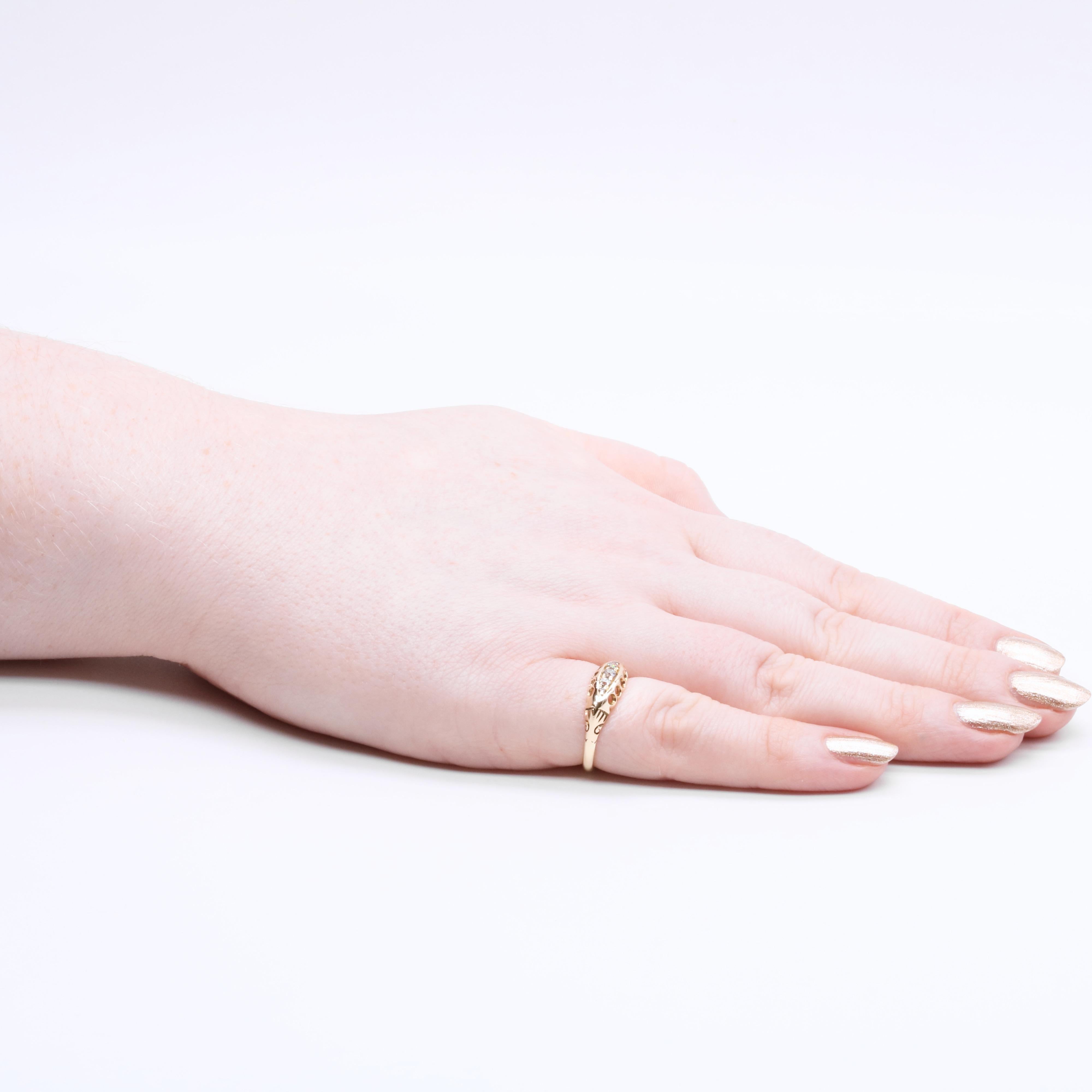 An antique diamond and yellow gold ring, comprising three old European cut diamonds and two rose cut diamonds, set in 18 karat yellow gold, to a band of 18 karat yellow gold. 

The ring is set with 5 sparkling diamonds, which graduate from the