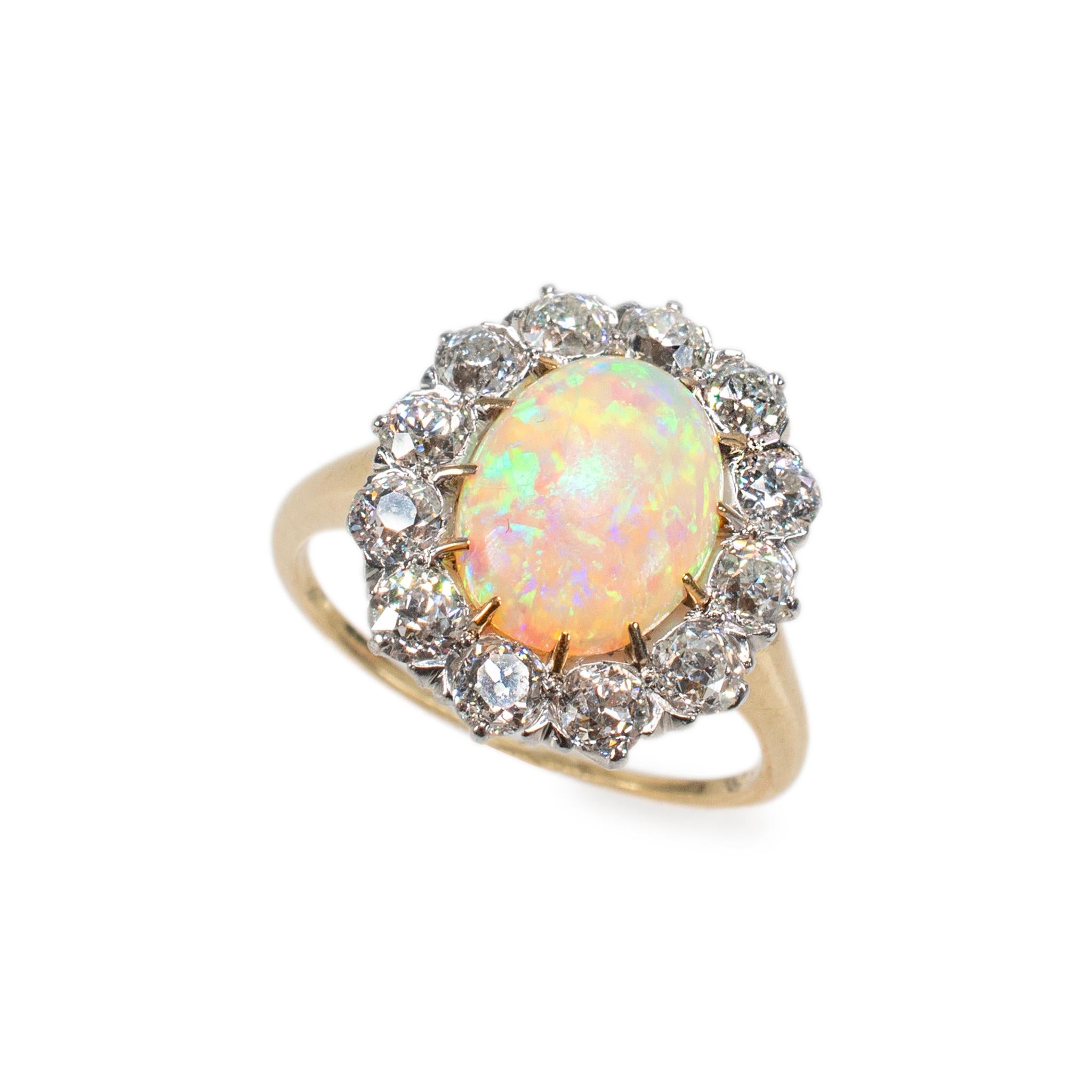 Gender: Ladies

Metal Type: 18K Yellow Gold & Platinum

Ring Size: 8

Head Measurement: 18.20 mm x 15.75 mm

Shank Maximum Width: 2.00 mm

Weight: 6.44 grams

Ladies 18K Yellow Gold and Platinum diamond and opal antique halo cocktail ring with a
