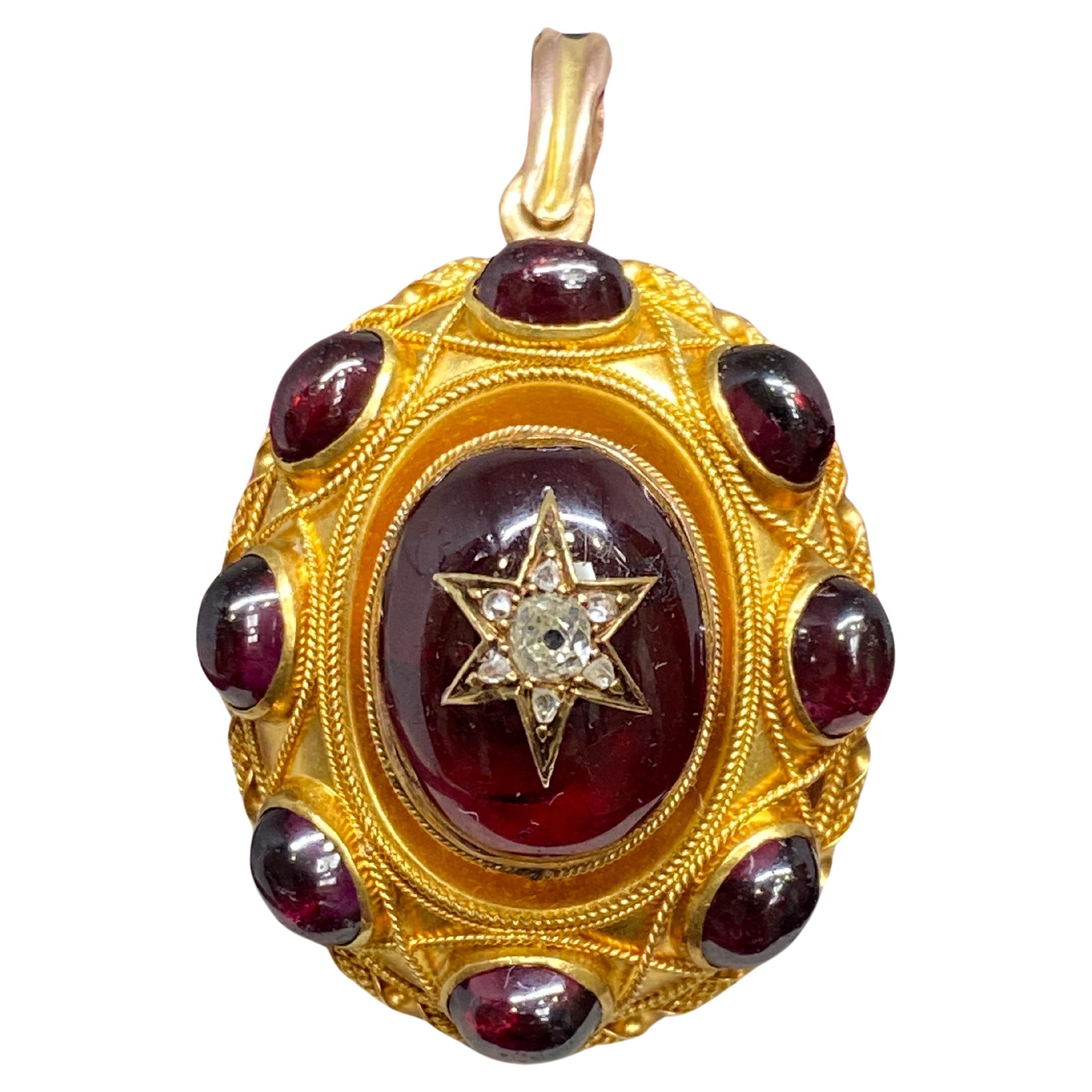 A gorgeous garnet and diamond locket pendant from the Victorian, circa 1870's era. This marvelous piece is crafted in vibrant 18kt yellow gold and features incredible 3-dimensional detail. At the center of the piece is a large, high domed