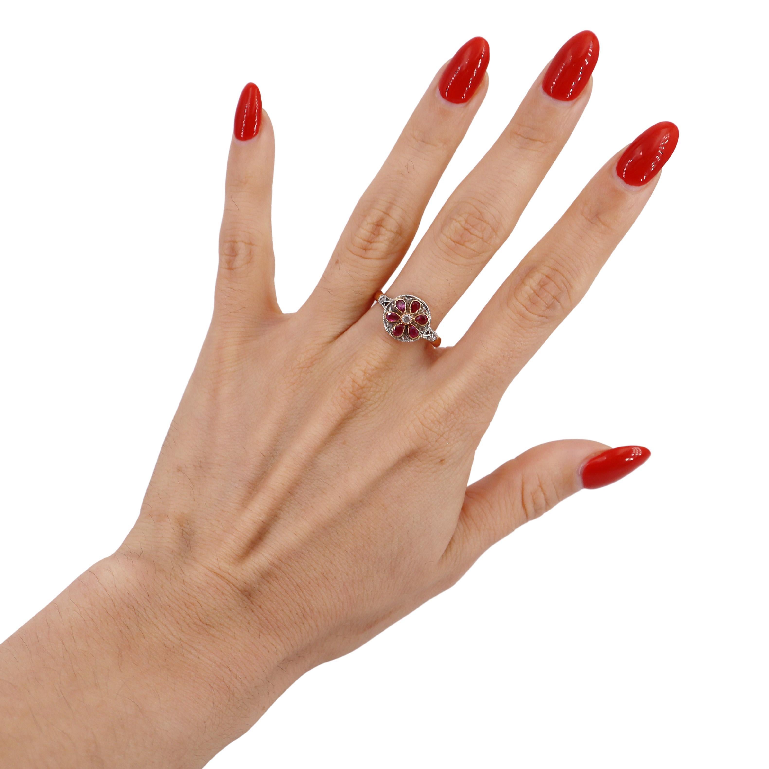 This exquisite antique ring is a stunning blend of artistry and elegance, meticulously crafted in 18kt rose gold with a luxurious platinum top. At its heart lies a captivating old mine diamond, surrounded by delicate rose cut diamonds that together