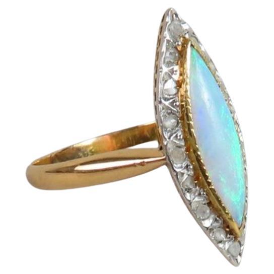 Pink gold (750/00) marquise ring set with a navette-cut opal in a setting of diamond roses. Gross weight: 2.1 gr
Size 5 1/2