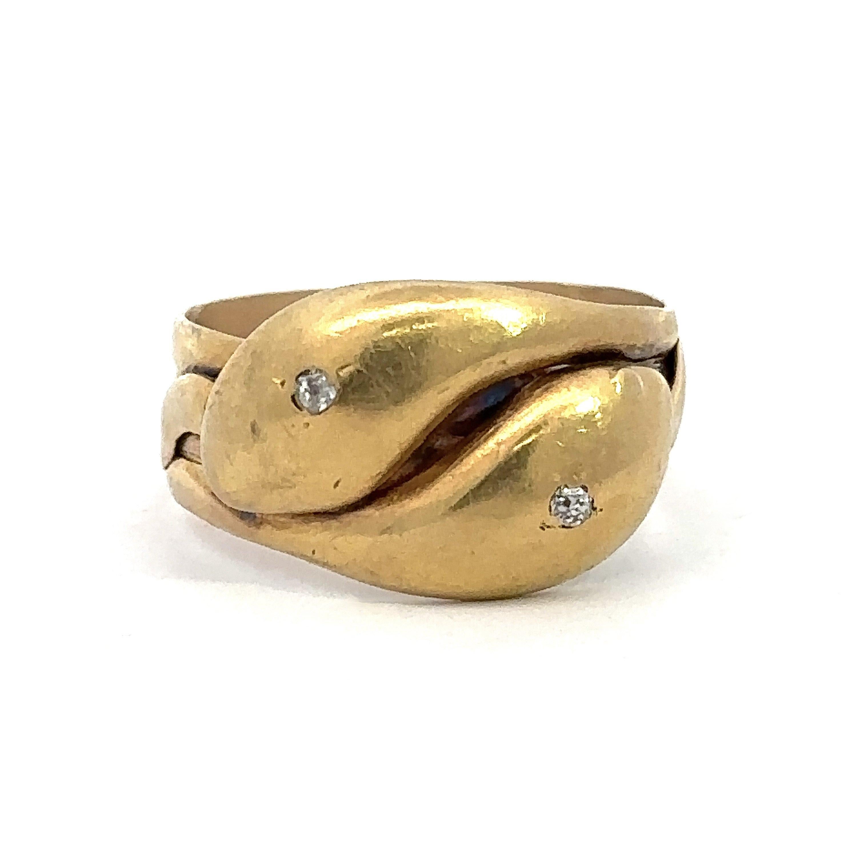 This antique double headed snake ring was made in London, England and dates from 1918. Crafted in 18KT yellow gold, the ring features English hallmarks, 1918, full British hallmarks London 1918 maker mark looks like JR. The ring is size 12 and it is