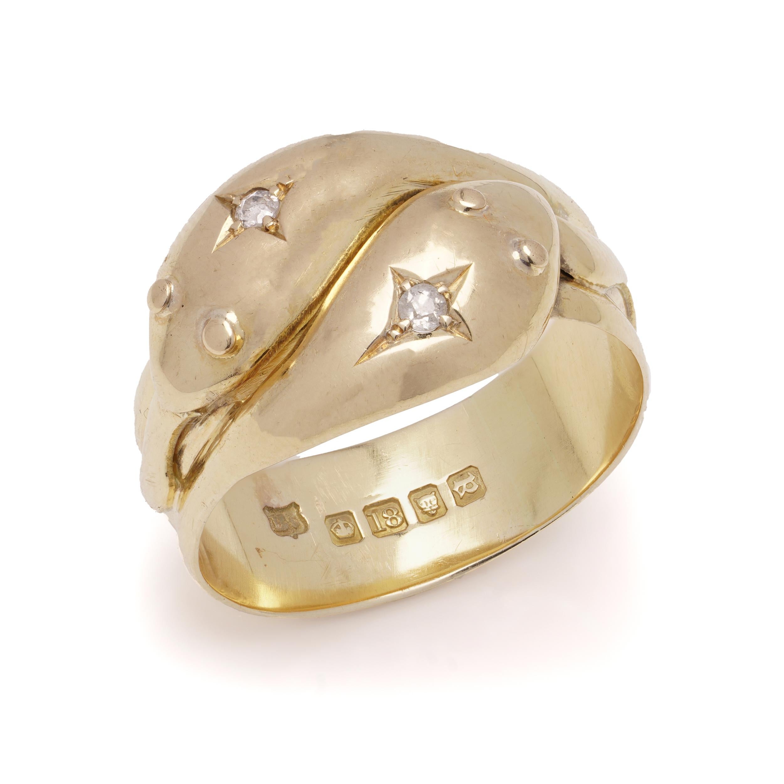 Antique 18kt yellow gold men's band ring in the shape of a pair of coiled snakes, featuring their tongues sticking out. The tops of their heads are set with two old-cut diamonds.
Made in the United Kingdom, London, 1916
Hallmarked with London town