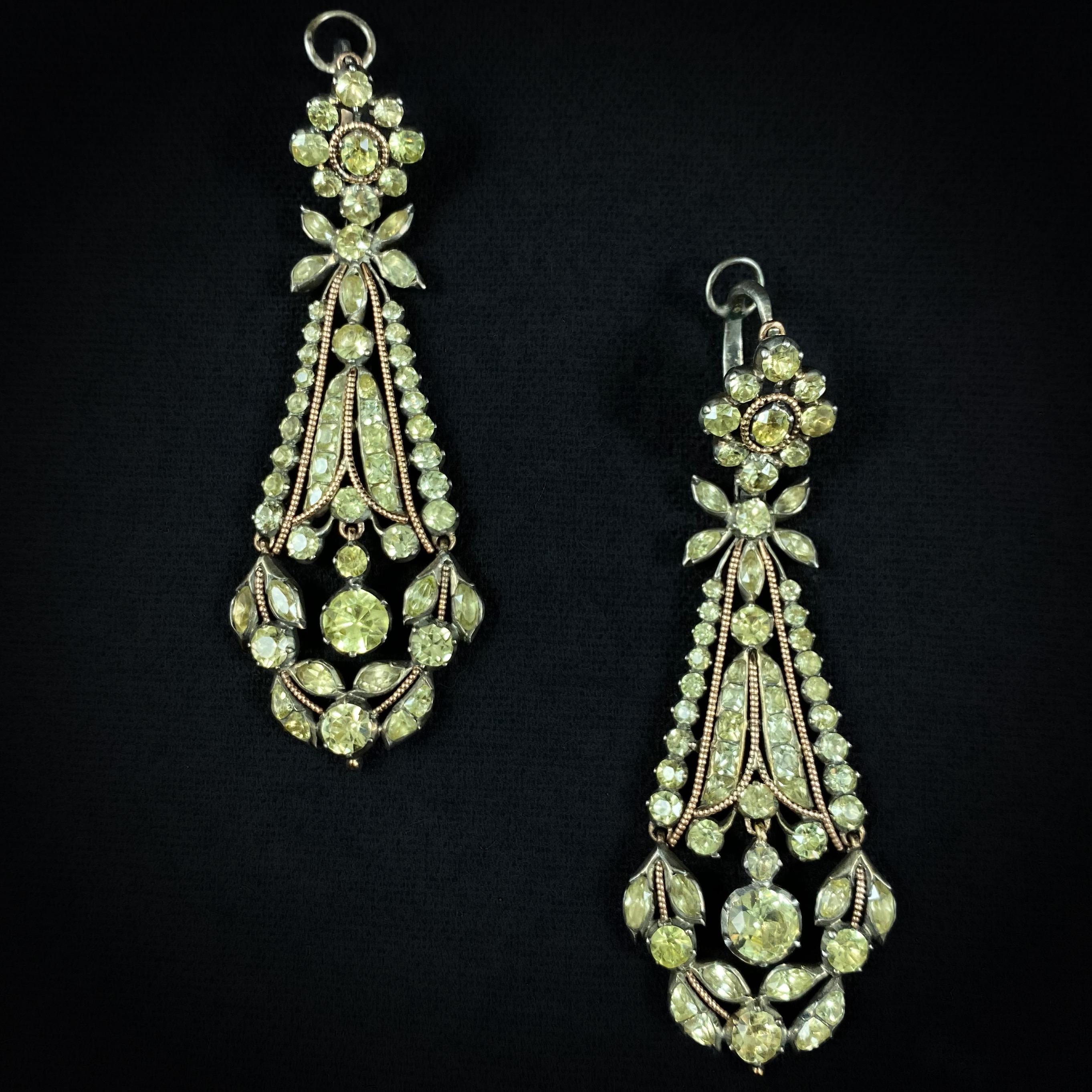 Museum Quality antique late 18th / early 19th century chrysolite chrysoberyl pendant drop earrings in silver and rose gold, probably Portugal, circa 1800. Of elongated and slightly exaggerated outline typical of the period, this design complimented