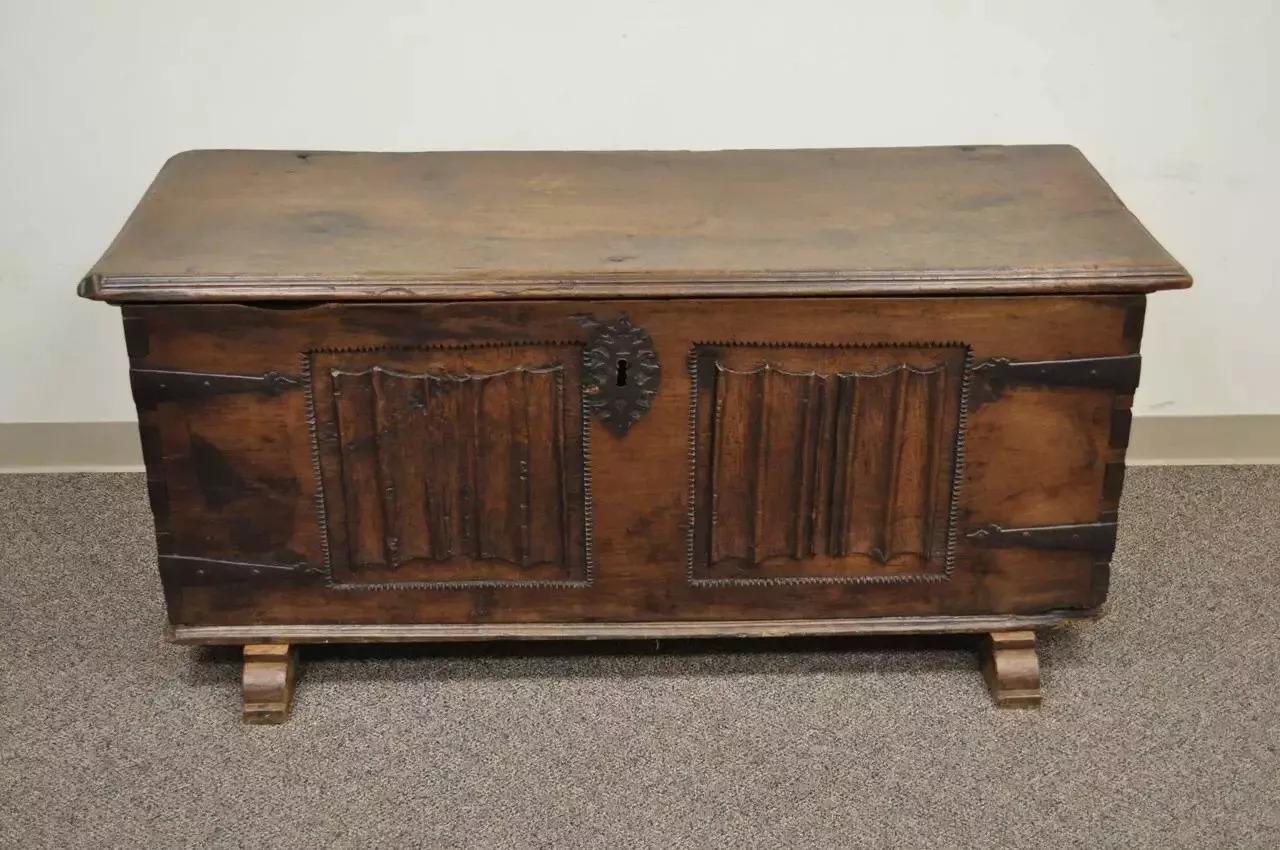 Antique 18th C. Gothic Renaissance Chestnut Large Coffer Blanket Chest Trunk. Item features hand carved detailing on the front panel, hand wrought iron hardware, a very thick and solid carved wood lid with beveled edges, attractive and desirable