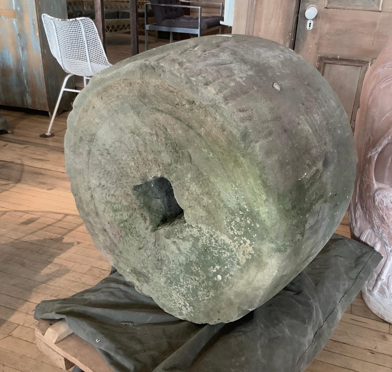 A beautiful example of these wonderful 18th century mill stones. This was used in a grain mill in NY state, and has great character. 

We have a pair available, both similar, priced individually.