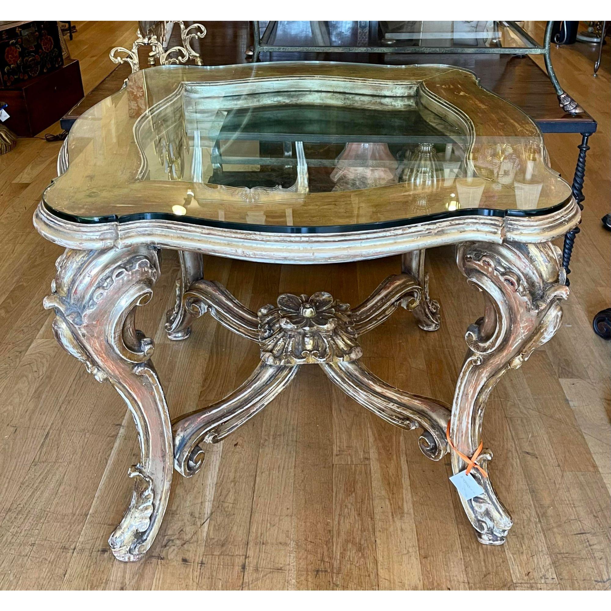 Antique 18th century style Rococo Venetian giltwood table with antiqued mirror.
Additional information:
Materials: Giltwood, mirror
Color: Gold
Period: 1920s
Place of Origin: Spain
Styles: Italian, Rococo
Table Shape: Other (unique