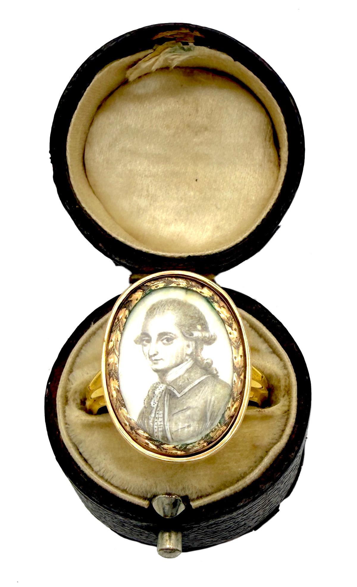 This substantial ring was created in the 3rd quarter of the 18th century out of solid 18K yellow gold. The ring is set with a three quarter portrait of a gentleman wearing an elegant wig, chemise, foulard and waistcoat. The three quarter portrait is