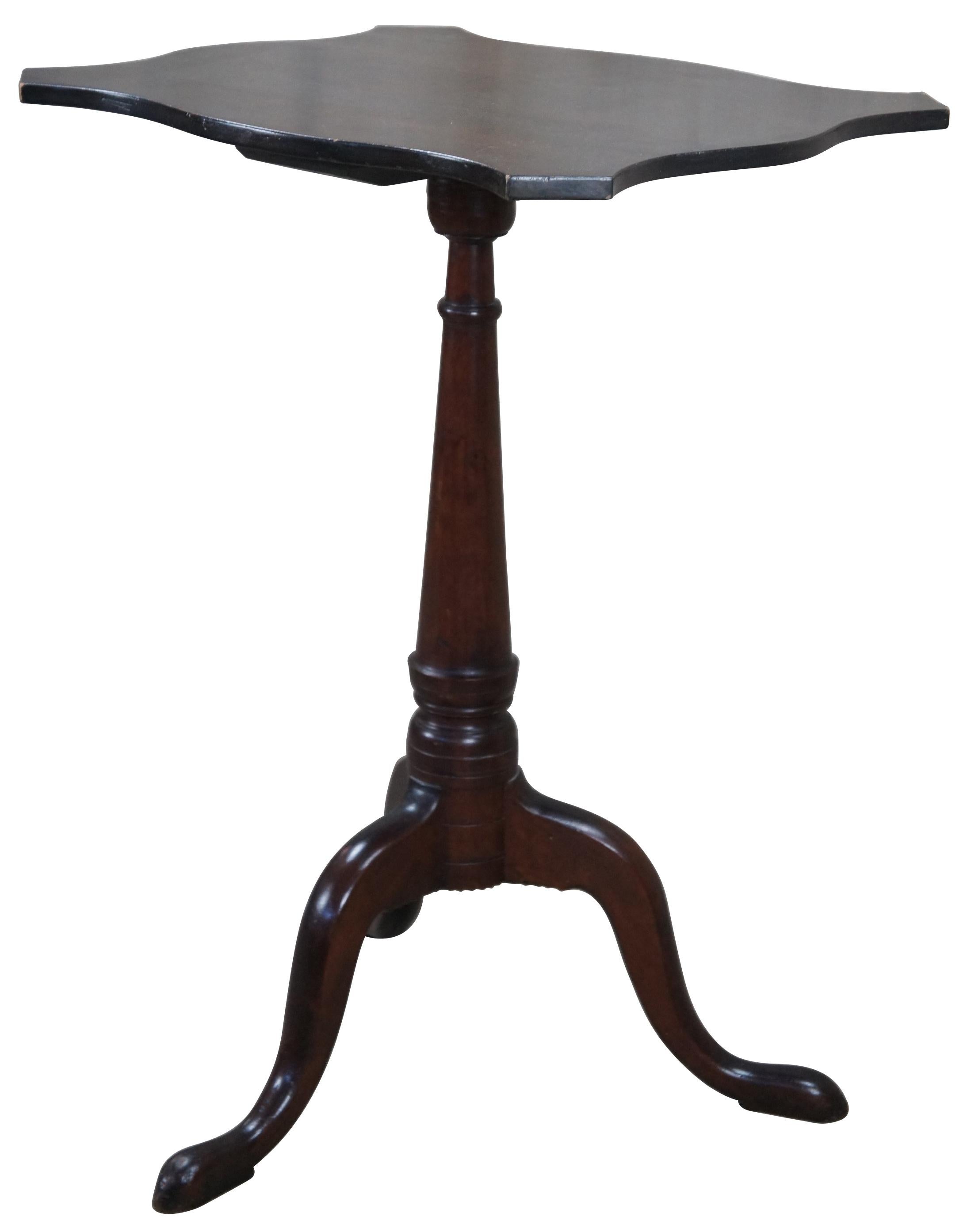 A beautiful 18th century colonial mahogany Newport, Rhode Island candlestand. Features a serpentine turtle top over a conical shaft leading to a tripod base with notched and shaped returns on cabriole legs and slipper feet. The conical shaft relates