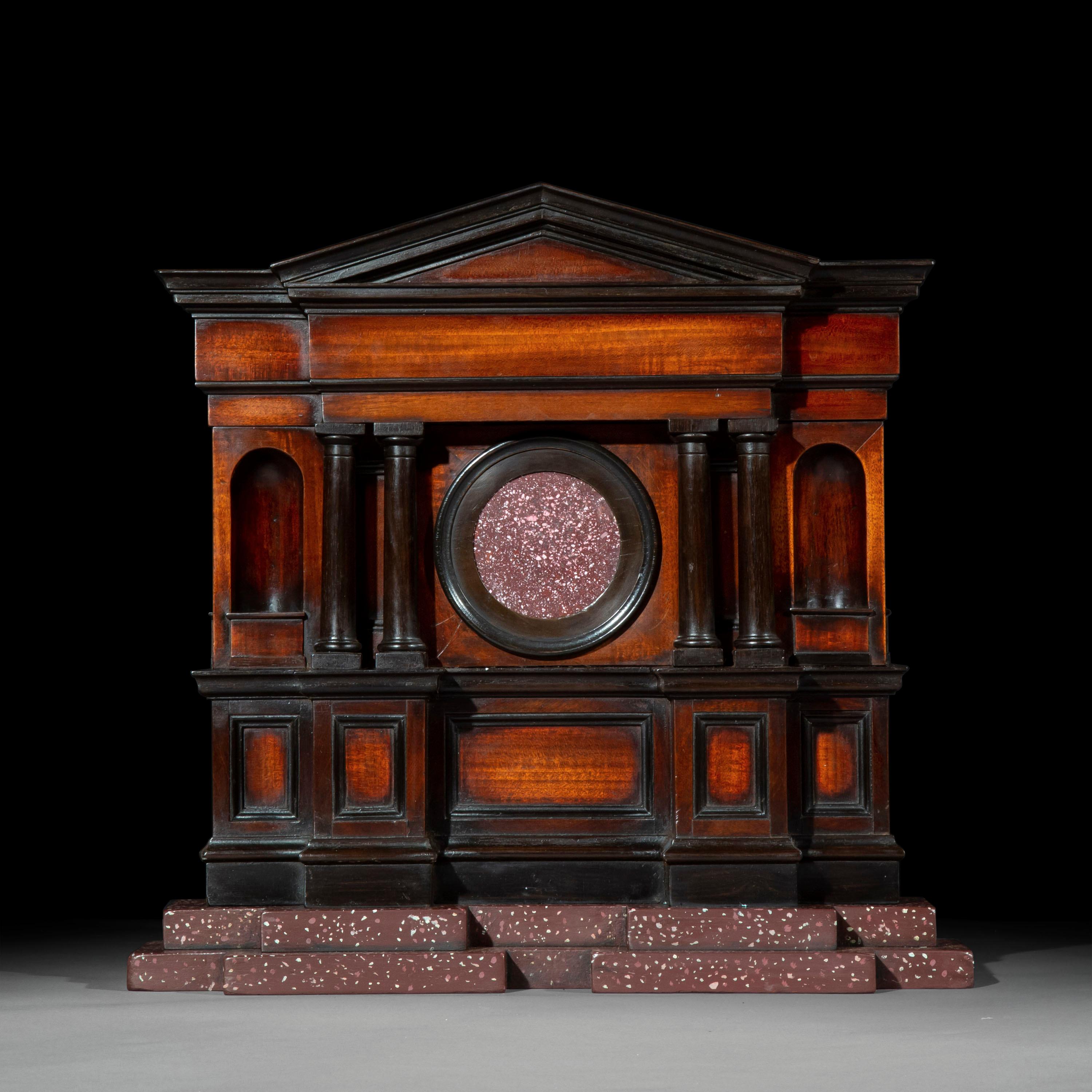 A superb quality George II period architectural model in mahogany and ebony, mounted with an Egyptian 'Imperial Porphyry' roundel.
England, circa 1750.

Why we like it
Exquisitely detailed throughout, this splendid object would have had a proud