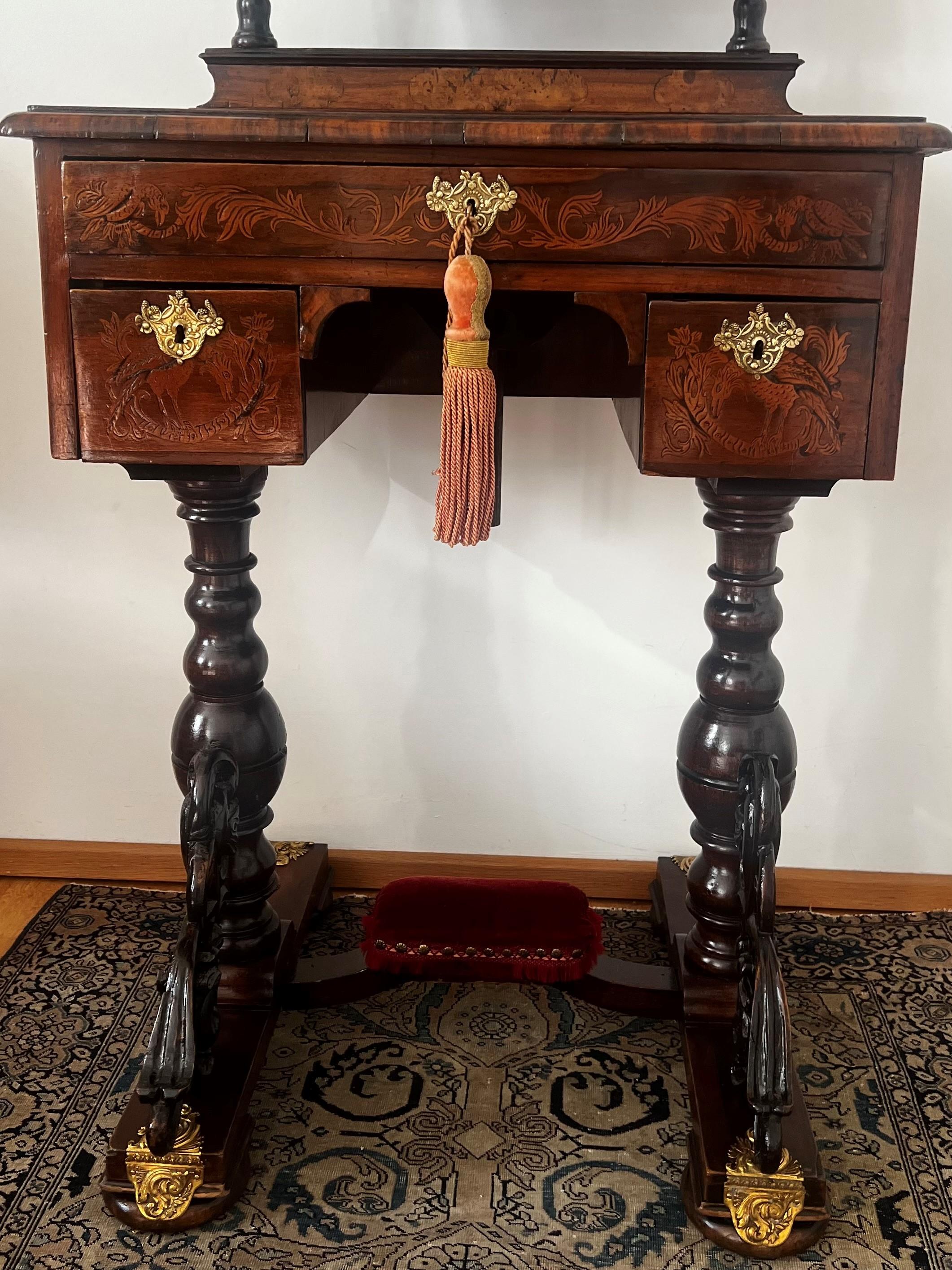 “MIRROR, MIRROR ON THE WALL, WHO’S THE FAIREST OF THEM ALL”?  

This ladies’ antique dressing table is elegant and playful. It decorated with gold gilded ornaments on the legs, mirror and on the table itself. The veneer inlays are absolutely