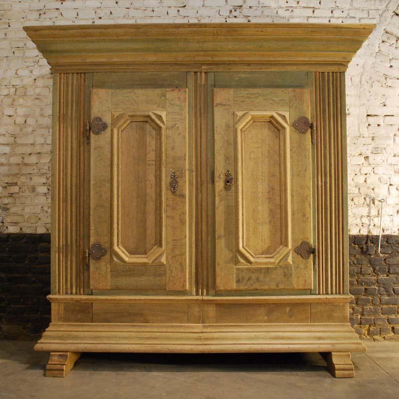 This solid oakwood cabinet originates in the German state of North Rhine Westphalia and it dates circa 1720. 
The cabinet is made in the finest quality watered oak. It is a two-door cabinet with a heavy molding at the top as well as the bottom end.