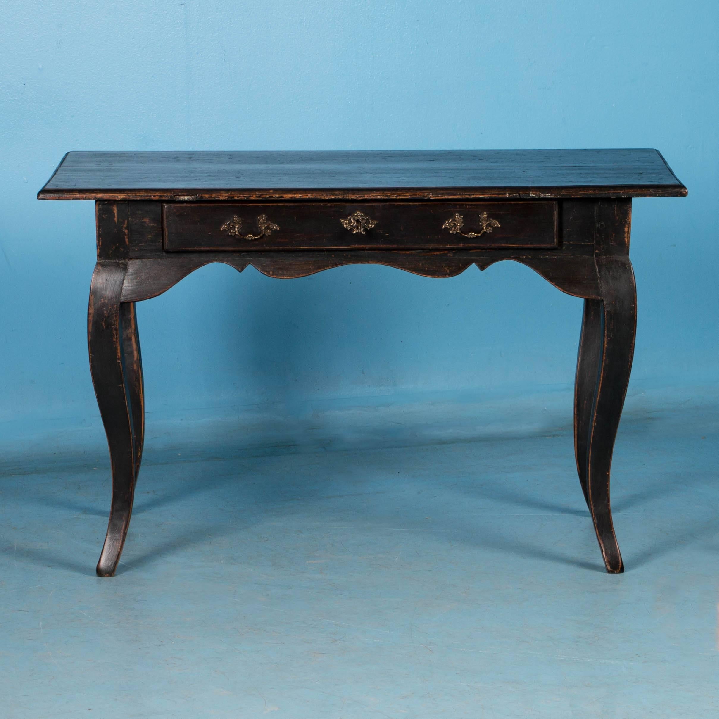 Antique 18th century Baroque side table with black paint.  The cabriole legs add a refined touch, and the single drawer adds to both the look and function of the desk. 