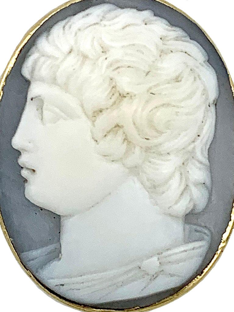 This rare button features a shell cameo of a young man carved in antique manner. The cameo is mounted in a silver button.
