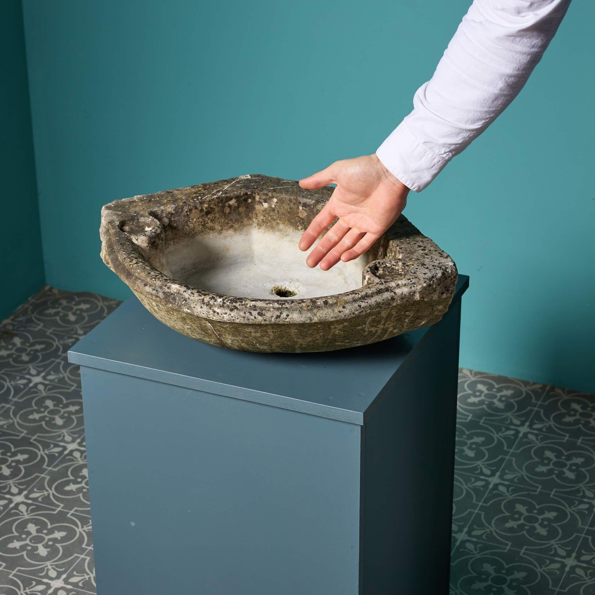 An antique carved Carrara marble corner basin dating to the 18th century.

This charming trough has certainly showcases a desirable weathered finish creating a characterful rustic country look. The two small shaped soap dishes only compliment, the