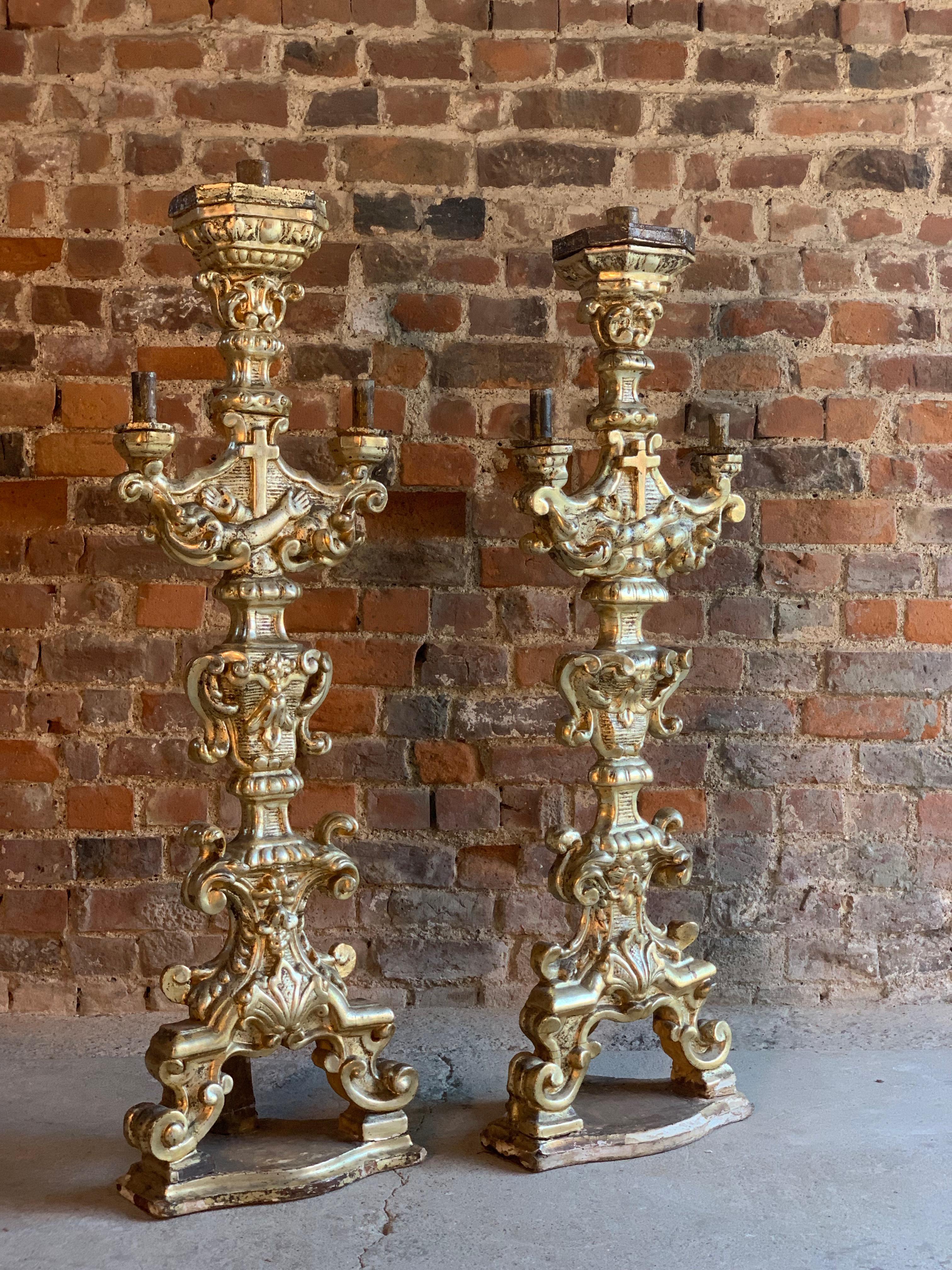 Antique 18th century carved Baroque candlesticks silvered Gesso and giltwood circa 1750.

A magnificent large pair of 18th century carved wooden Baroque church altar candlesticks circa 1750, the wooden candlesticks gesso and gilding with the