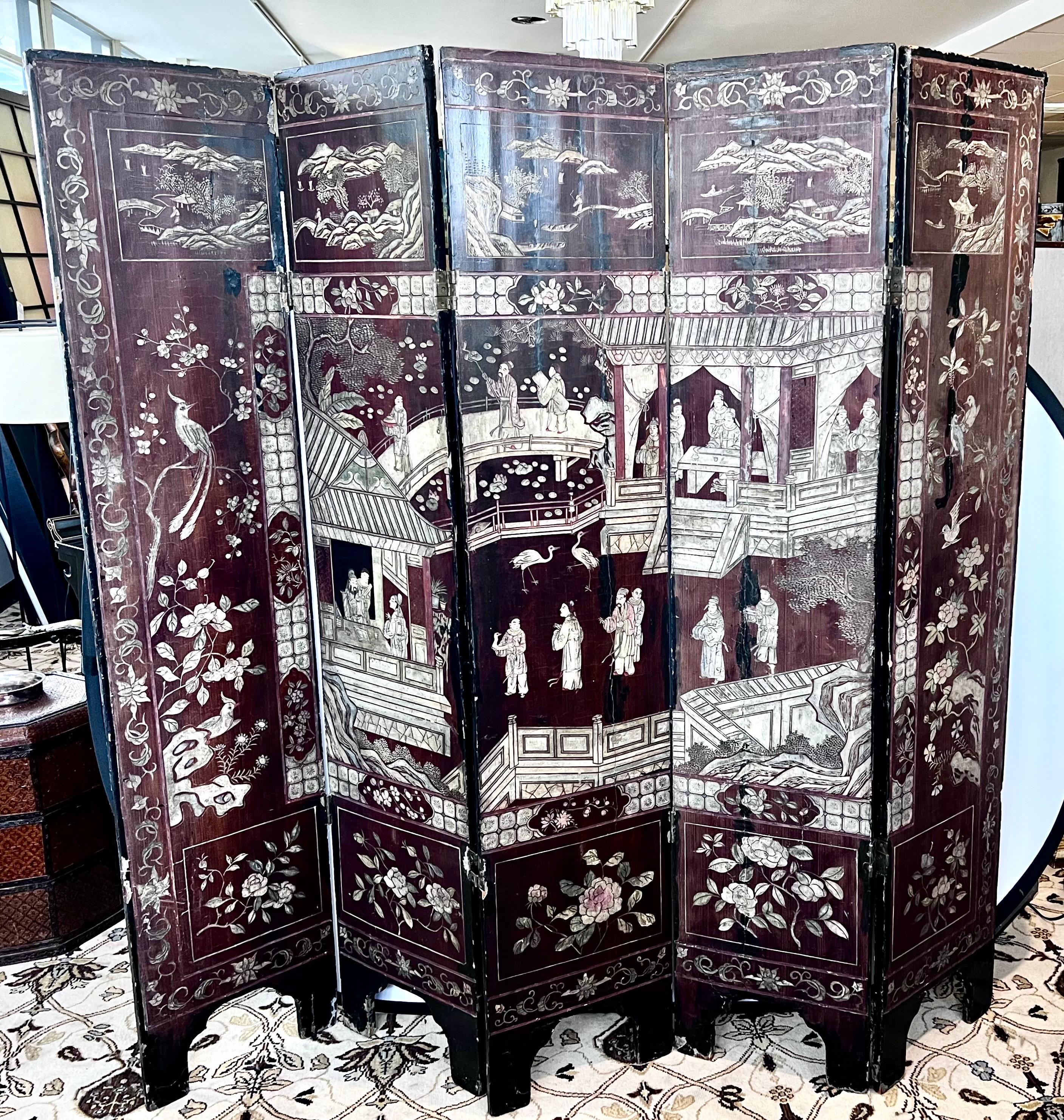 This rare antique 19th Century Chinese 5 panel Coromandel screen features incredible craftsmanship and period detail.  The five panels are carved on both sides, with one side depicting scholars and buildings while the other depicts warriors on