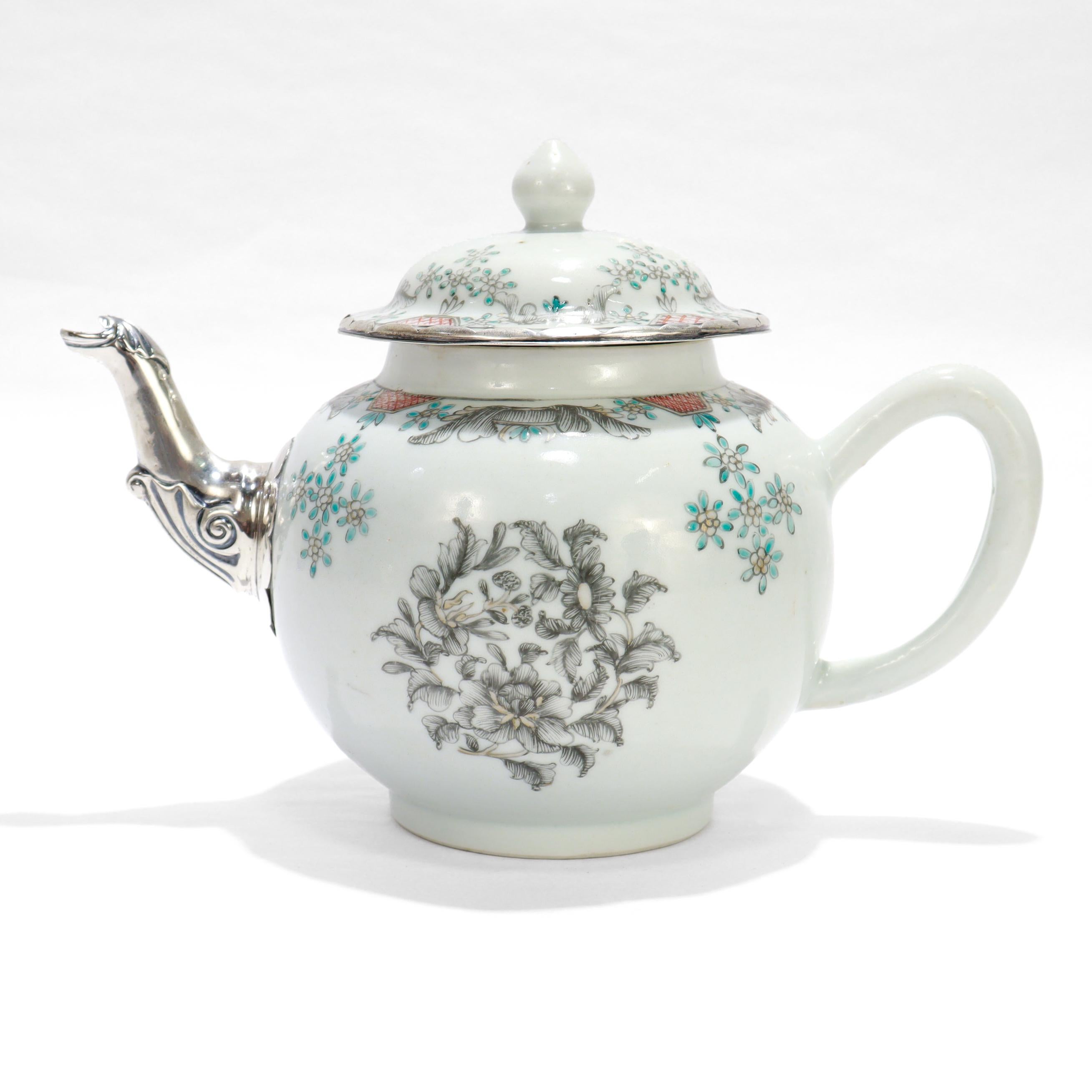 A fine 18th century Chinese Export porcelain teapot.

Decorated throughout with flowers & floral sprays en grisaille and with red, turquoise, and gilt embellishments.

The pot with a make-do silver spout replacement and the lid with a silver